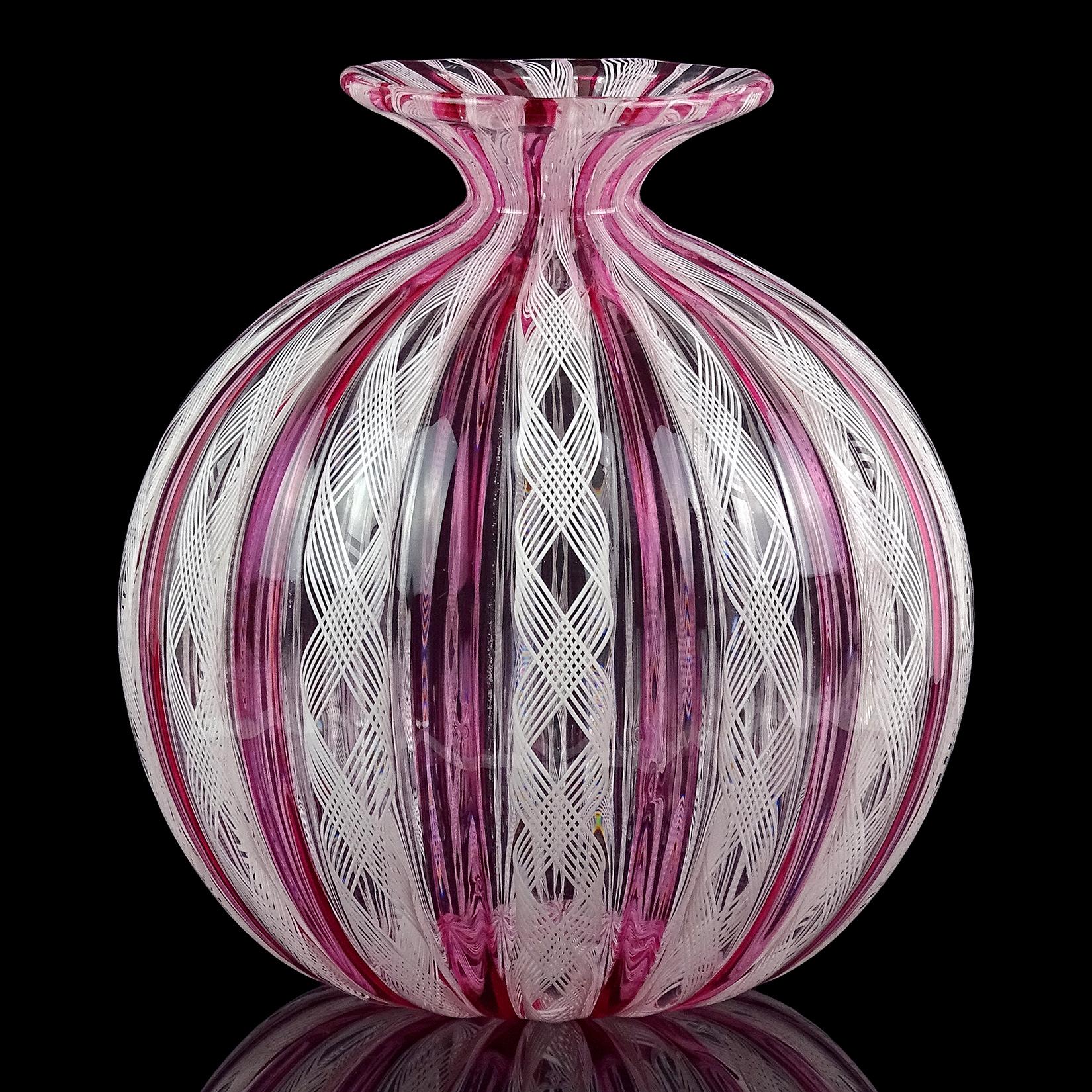 Beautiful vintage Murano hand blown pink amethyst and white ribbons Italian art glass bud or specimen / soliflore flower vase. Created with alternating transparent pink canes, and Zanfirico ribbons. It has a pinched in neck, with flared rim. Has an