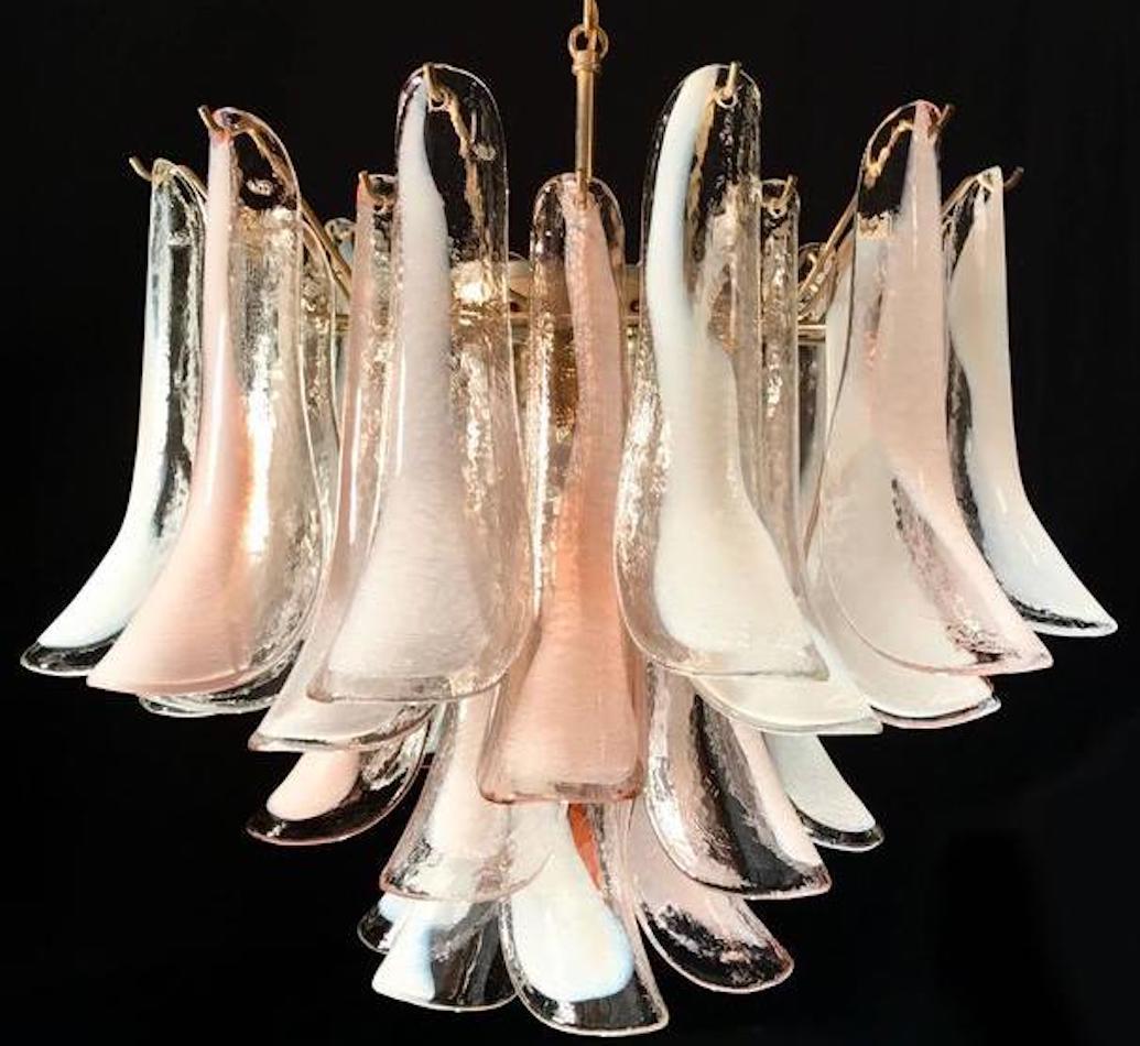 Amazing Italian vintage Murano chandelier by Mazzega. Made by pink and white “lattimo” glass petals. Brass frame with six E 14 light bulbs.
 Price is \1  item 
 Available also a pair 
Perfect vintage condition.