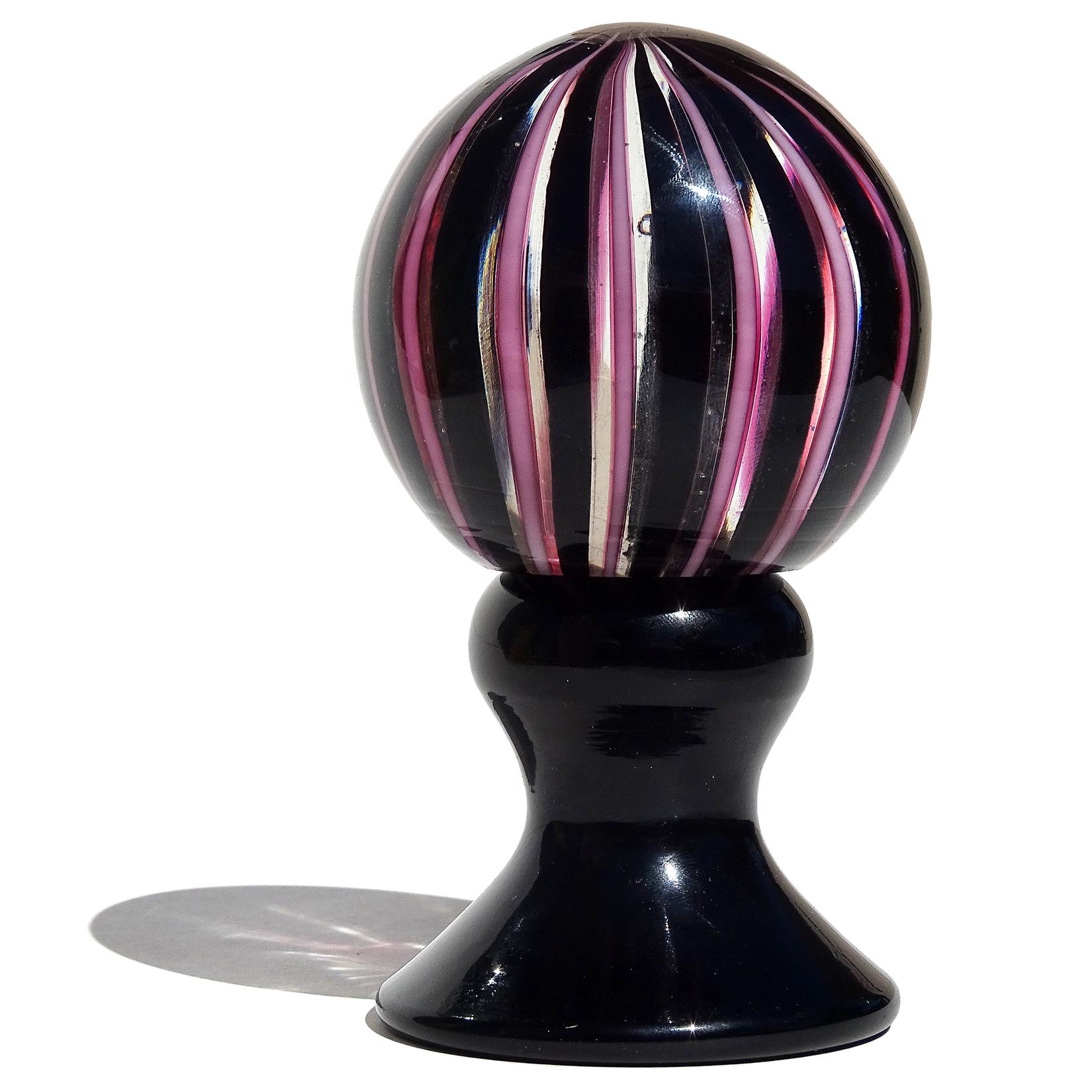 Gorgeous vintage Murano hand blown pink and black Filigrana ribbons Italian art glass pedestal paperweight. Created in the same style and color combination as Venini pieces by Bianconi and Paolo Venini. The paperweight has an original 