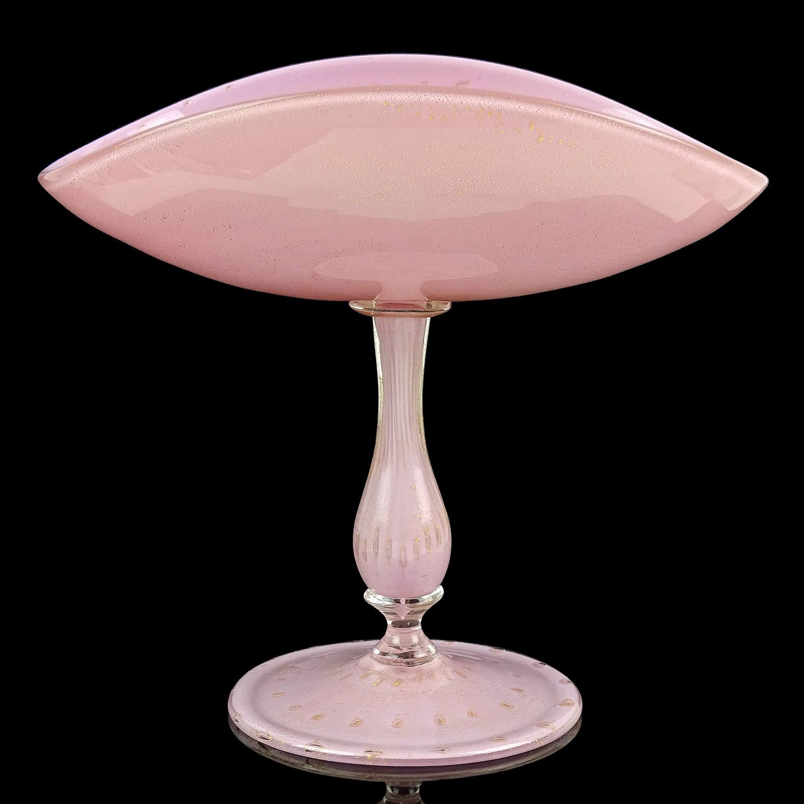Gorgeous vintage Murano hand blown pink, controlled bubbles and gold flecks Italian art glass pedestal compote bowl. Attributed to designer Alfredo Barbini, circa 1950s. Profusely covered in gold leaf inside and out. Created in the 