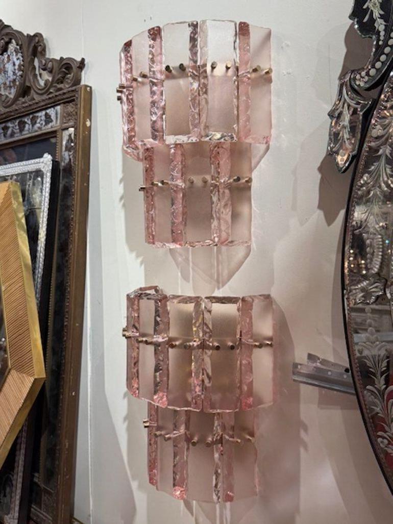 Pair of modern Murano pink ice block wall sconces. Murano pink ice block wall sconces bring a bold yet romantic glow to any space, blending vintage charm with artisanal glasswork. Circa 2000. 14w x 7d x 15h 