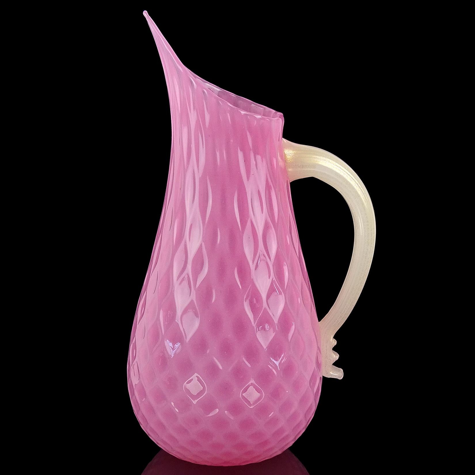 Beautiful and large, vintage Murano hand blown opalescent pink and gold flecks Italian art glass pitcher / flower vase. The piece has a diamond quilted design, creating a unique pattern throughout the body. it also has a large applied handle. The