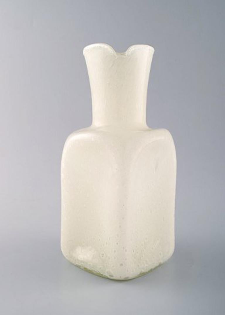 Murano pitcher with handle in light mouth blown artificial glass, 1960s.
Designed with bubbles in the glass mass.
In perfect condition.
Measures: 24.5 x 15 cm.