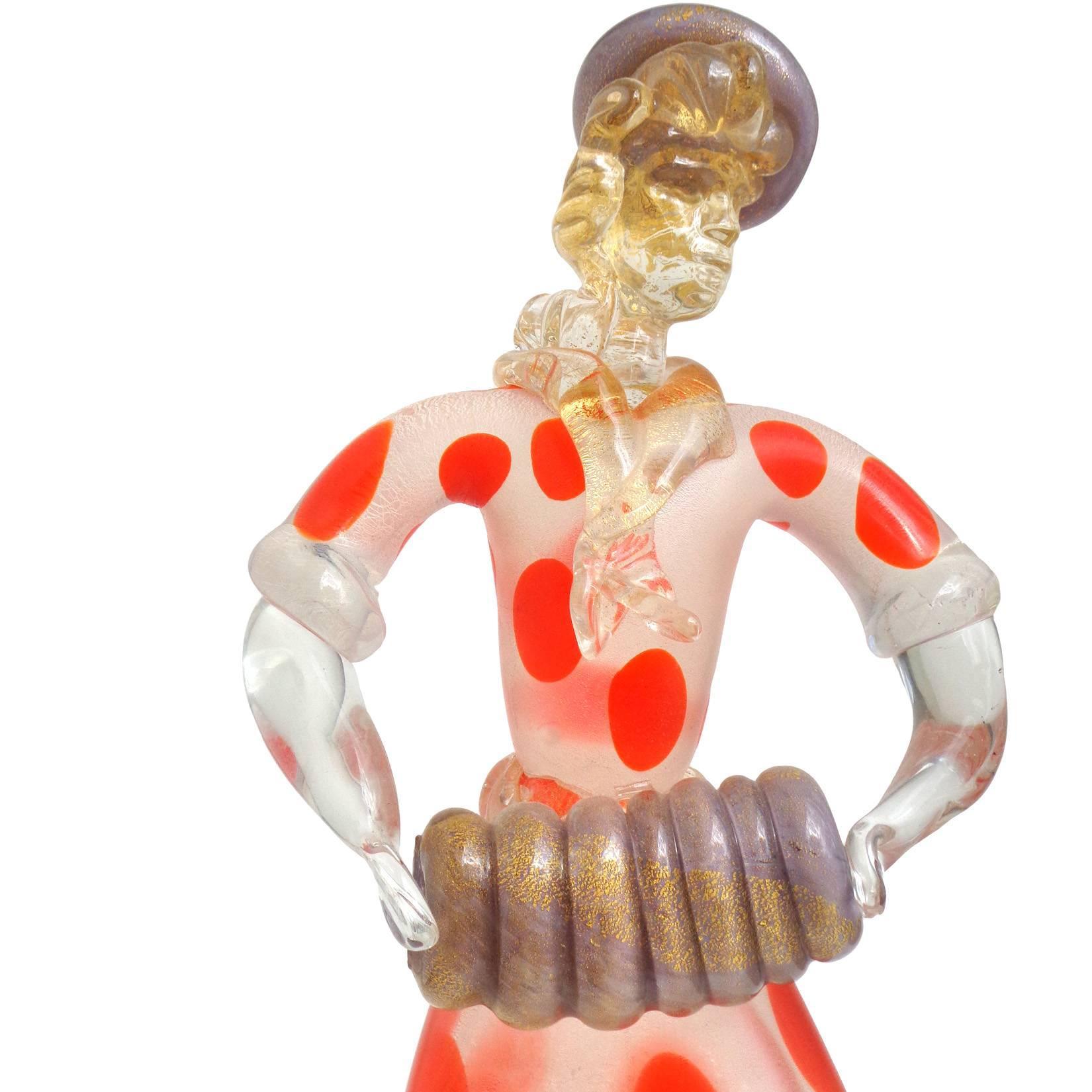 Gorgeous, and very unusual, vintage Murano hand blown orange polka dot, purple and gold flecks Italian art glass Parisian woman playing an accordion. Her dress has an acid texture surface with dot pattern. She is accented with gold leaf throughout,