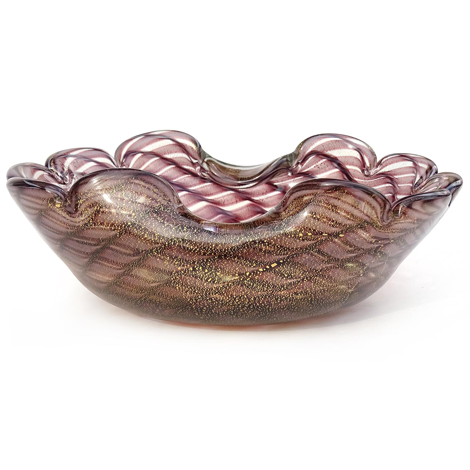 Beautiful vintage Murano hand blown purple and gold flecks Italian art glass decorative bowl. Created in the manner of the Barovier & Toso and Seguso companies. The bowl has a bold swirling pattern in dark and light purple. The design looks like a