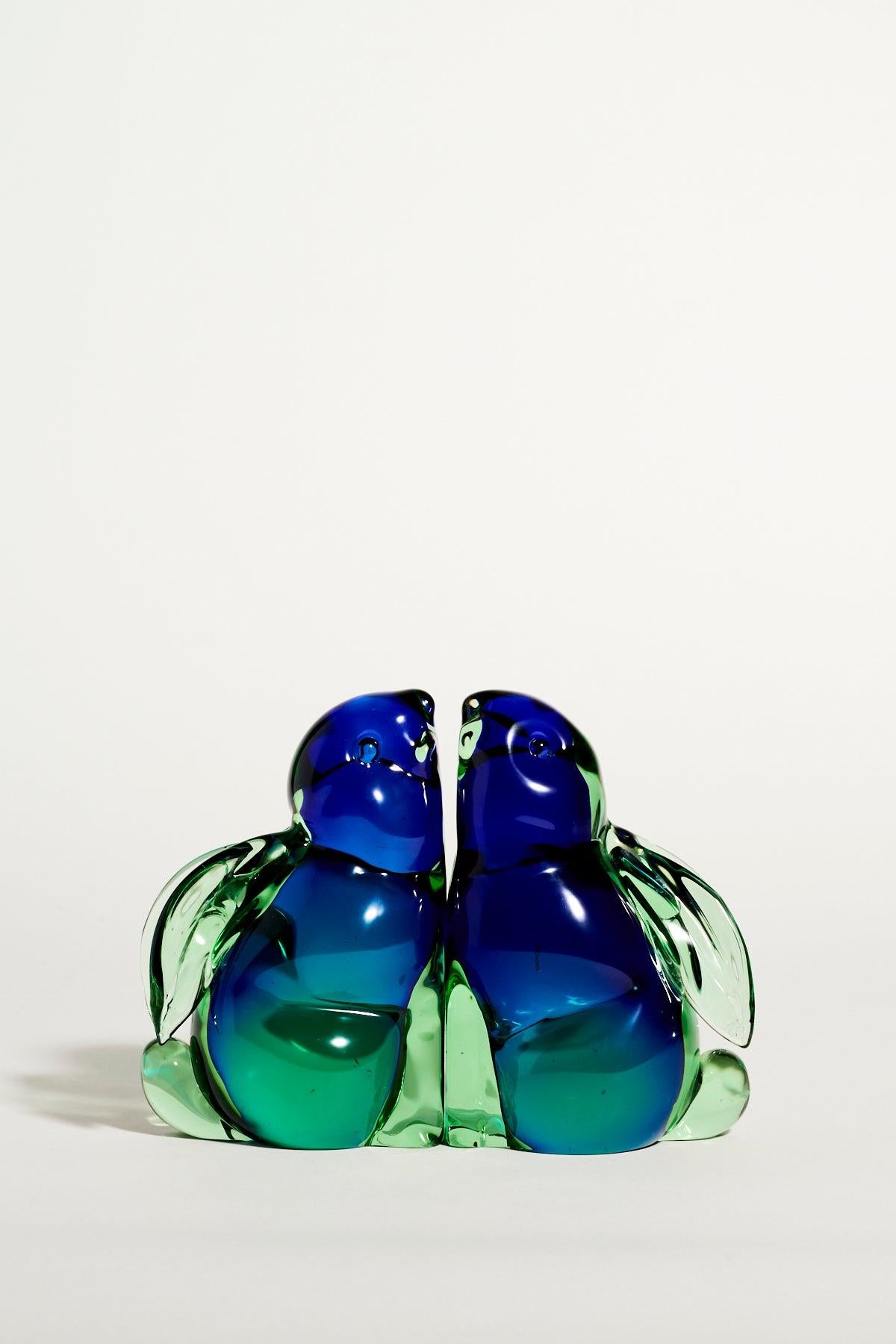Murano glass rabbit bookends in layered shades of blue and green, one with repaired ear.