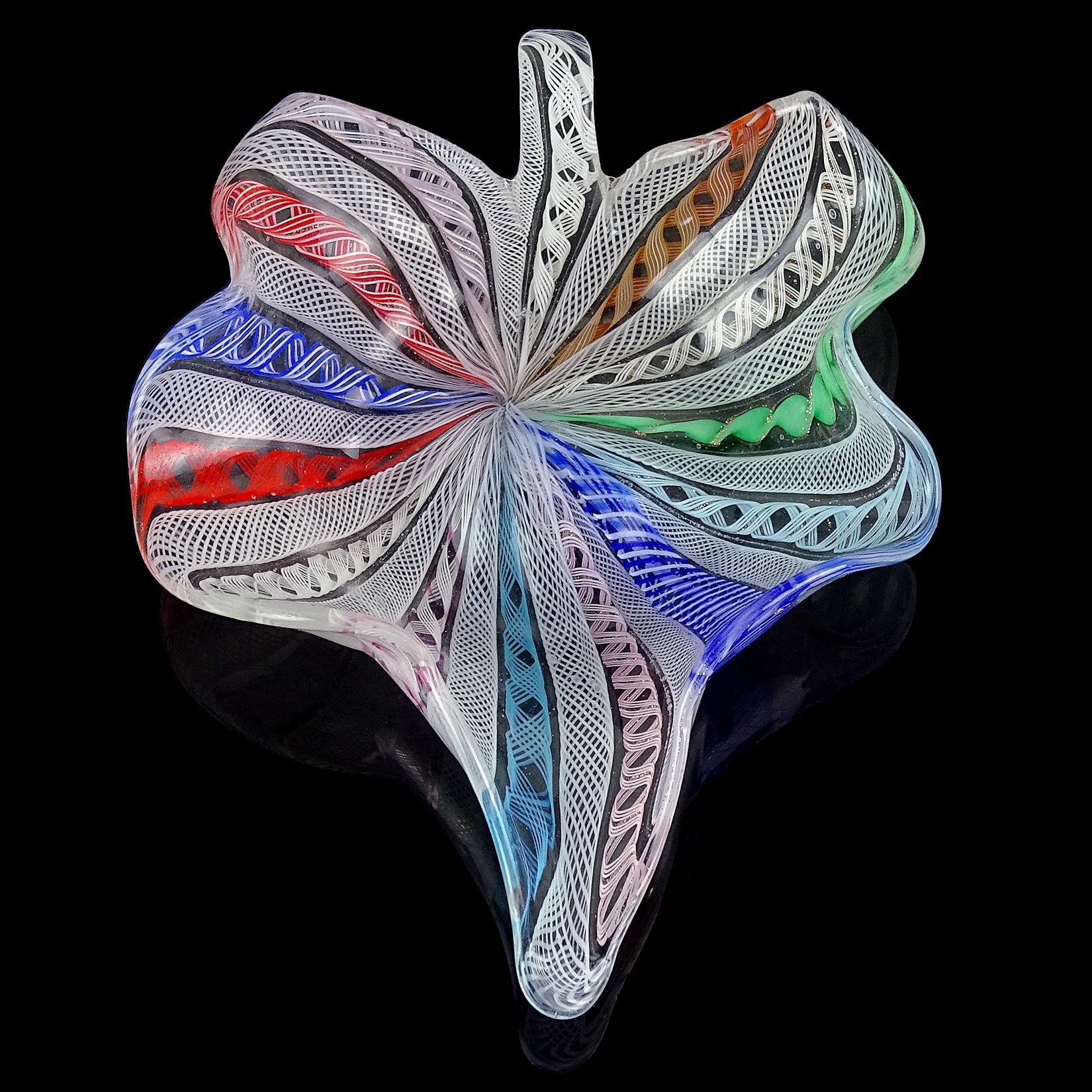 Beautiful vintage Murano hand blown rainbow and white ribbons Italian art glass leaf shaped bowl, dish. Attributed to the Fratelli Toso company. Made with intricate twisting Zanfirico ribbon in different designs. It has cobalt and light blue, pink,