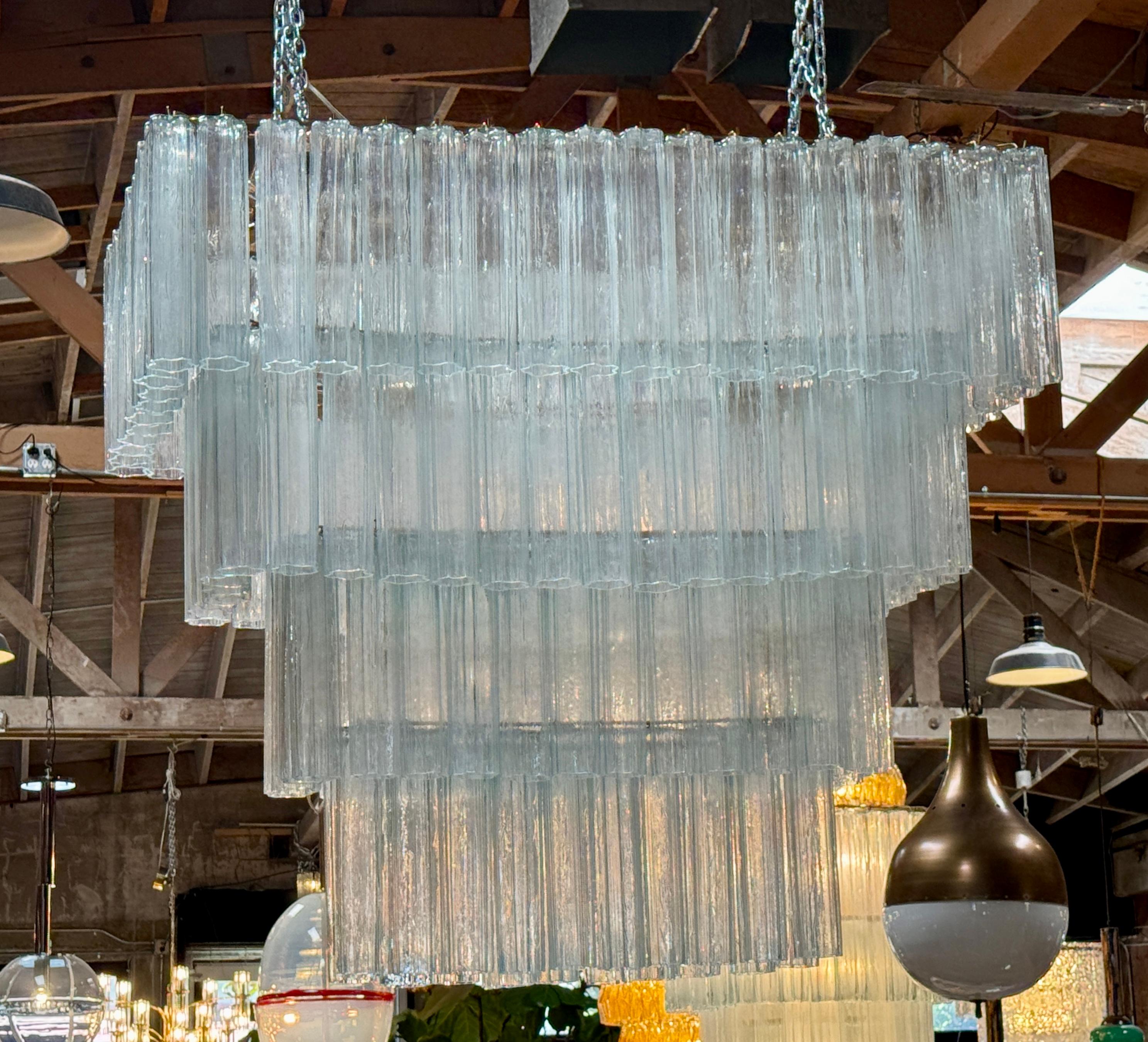 This chandelier is a striking example of mid-20th-century Murano craftsmanship, composed of 148 transparent “Triedro” glass elements. Each glass piece is hand-blown in the traditional Murano method, shaped with a tri-lobed or prism-like profile