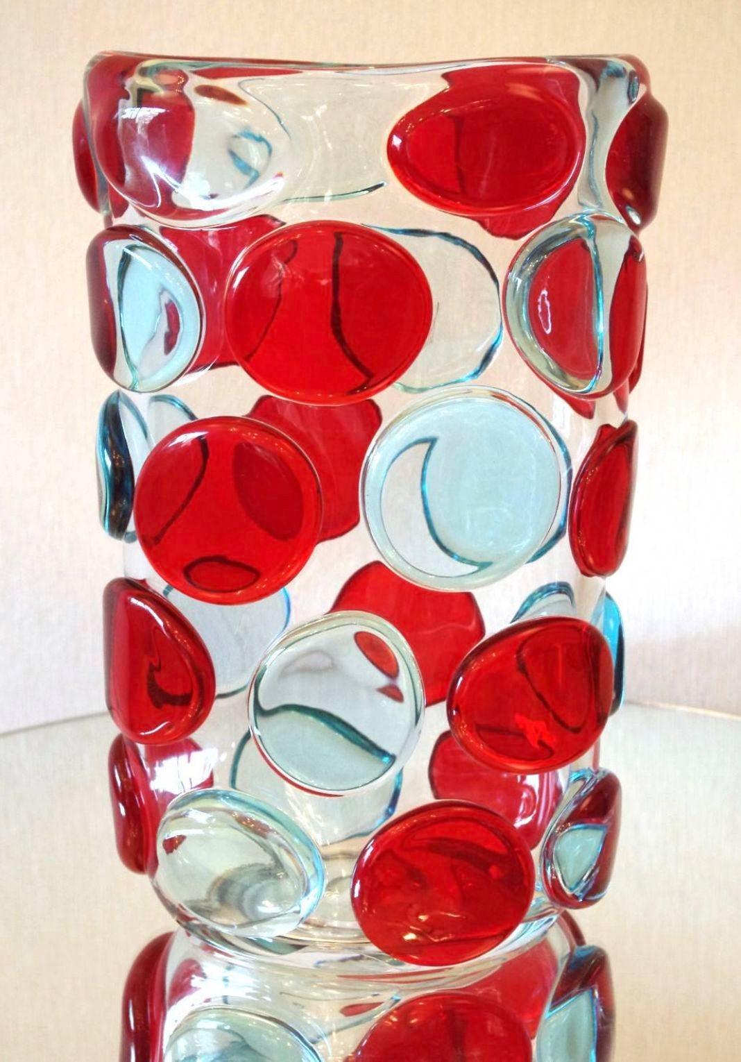 Beautiful vase with clear murano glass body and decorative red and light blue murano glass buttons by Camozzo and signed on the base.
Made in Italy in the 1970’s
Measures: height: 13.5 inches / width: 9 inches / depth: 5.5 inches.