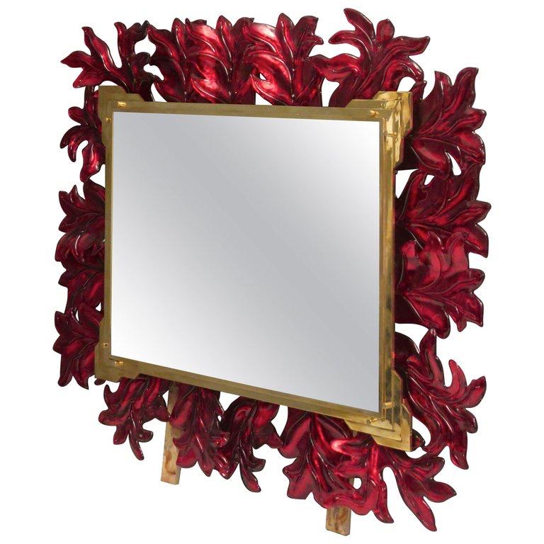 Stunning mirror in blazing red Murano glass, Venice. A mirror that alone will furnish your home environment.

The back rectangular structure is made of iron. All around the perimeter of the structure are positioned the leaves in red Murano glass.