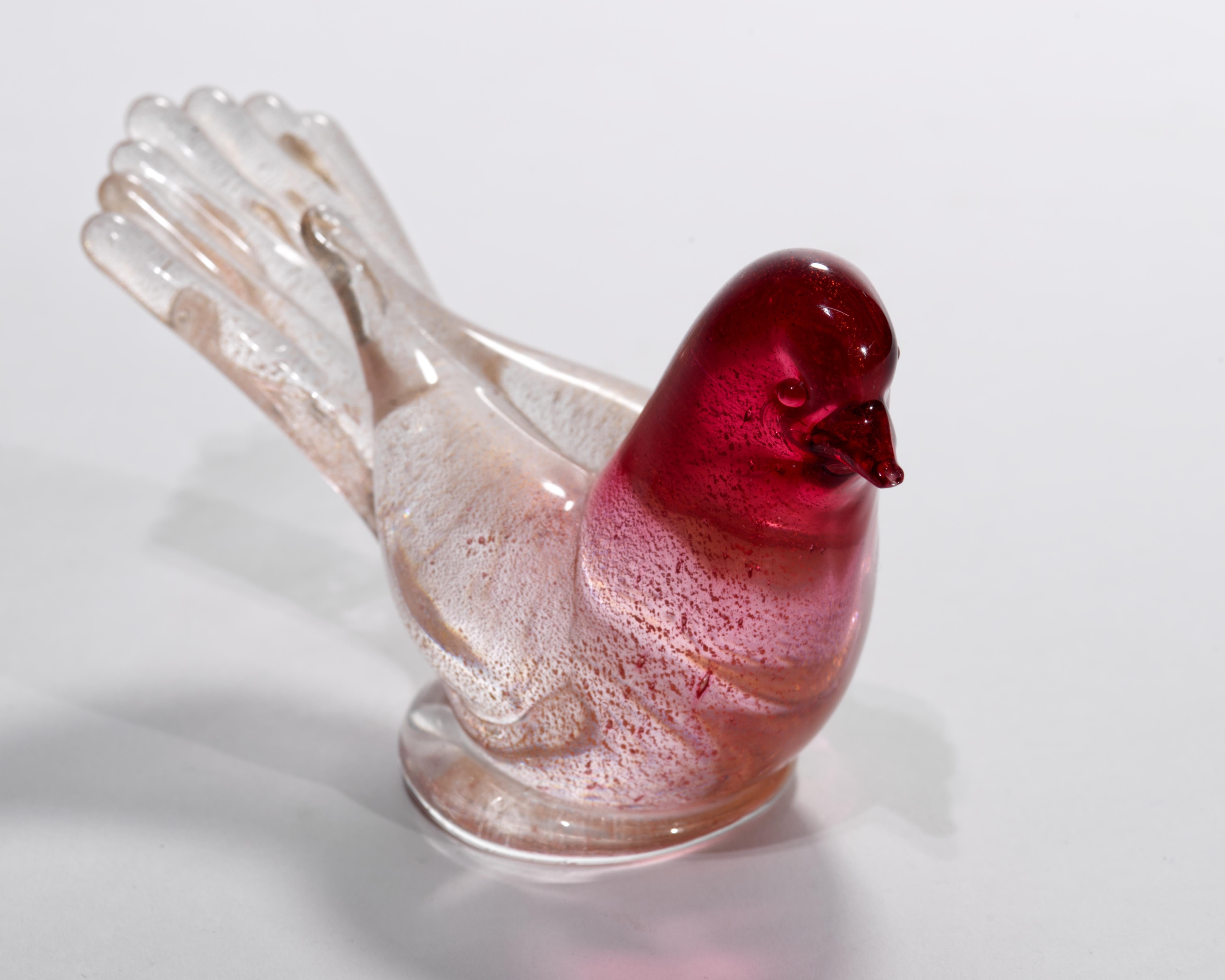  Murano hand blown Italian art glass bird sculpture or figurine features a minimal, restrained palette of dark red and off-white with delicate gold lead, or aventurine, accents. The colored glass is encased in a layer clear glass in sommerso