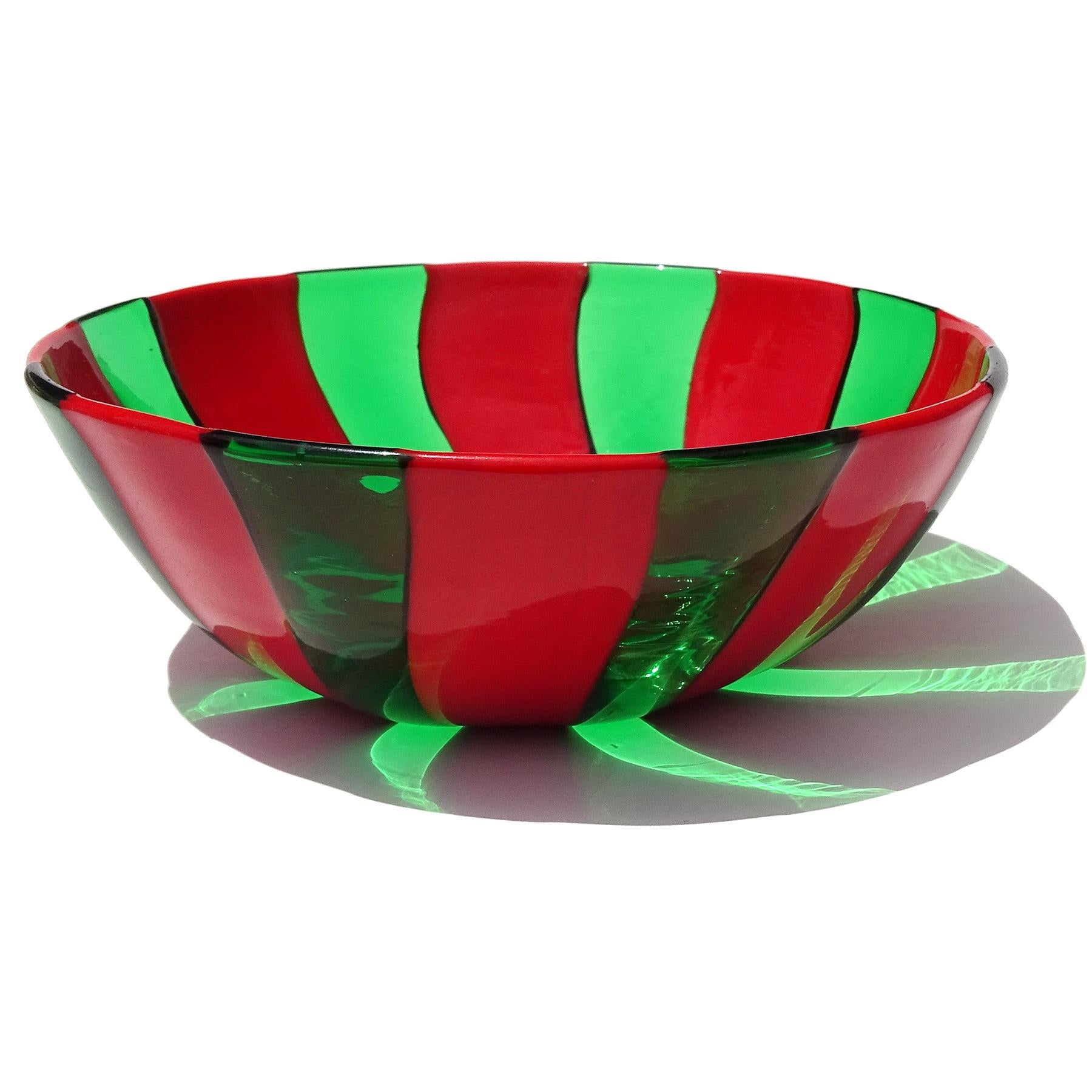 Beautiful vintage Murano hand blown red and green stripes Italian art glass decorative dish, vide-poche bowl. The piece was create in a very thin glass, with alternating pattern of solid red and transparent green bands. You can feel each of the
