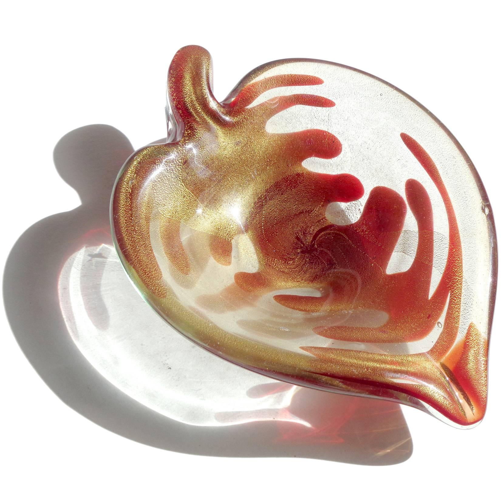 Beautiful vintage Murano hand blown blood red and gold flecks Italian art glass leaf bowl. The piece has a unique design, looking like veins on a heart, and is profusely covered in gold leaf. Can be used as a display piece on any table. Use it as a