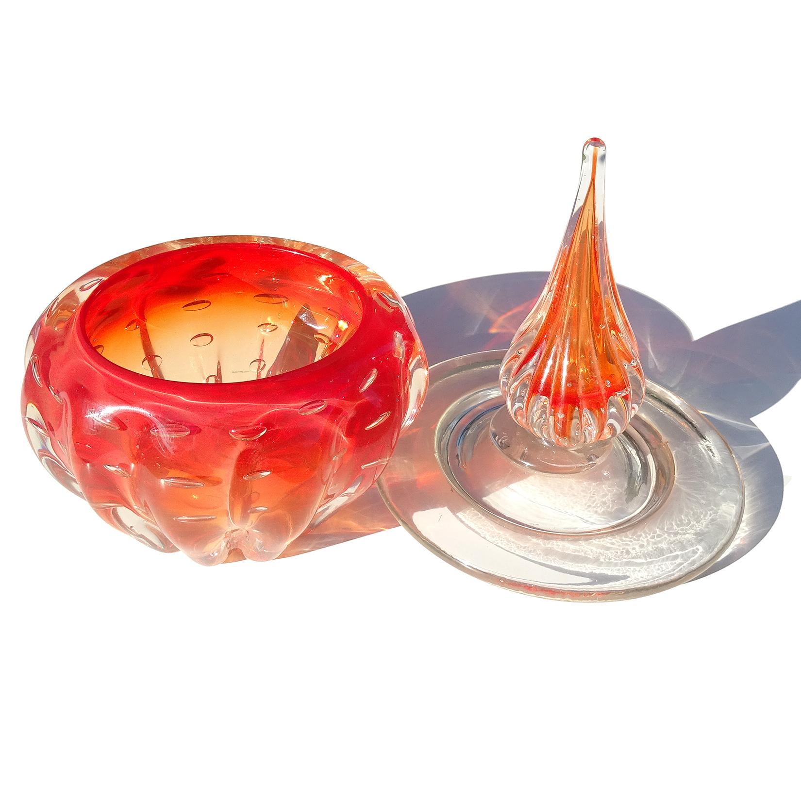 Beautiful vintage Murano hand blown Sommerso red orange and bubbles Italian art glass lidded vanity dresser jar. The piece has a ribbed body, with large clear lid and spike topper. Made in the 