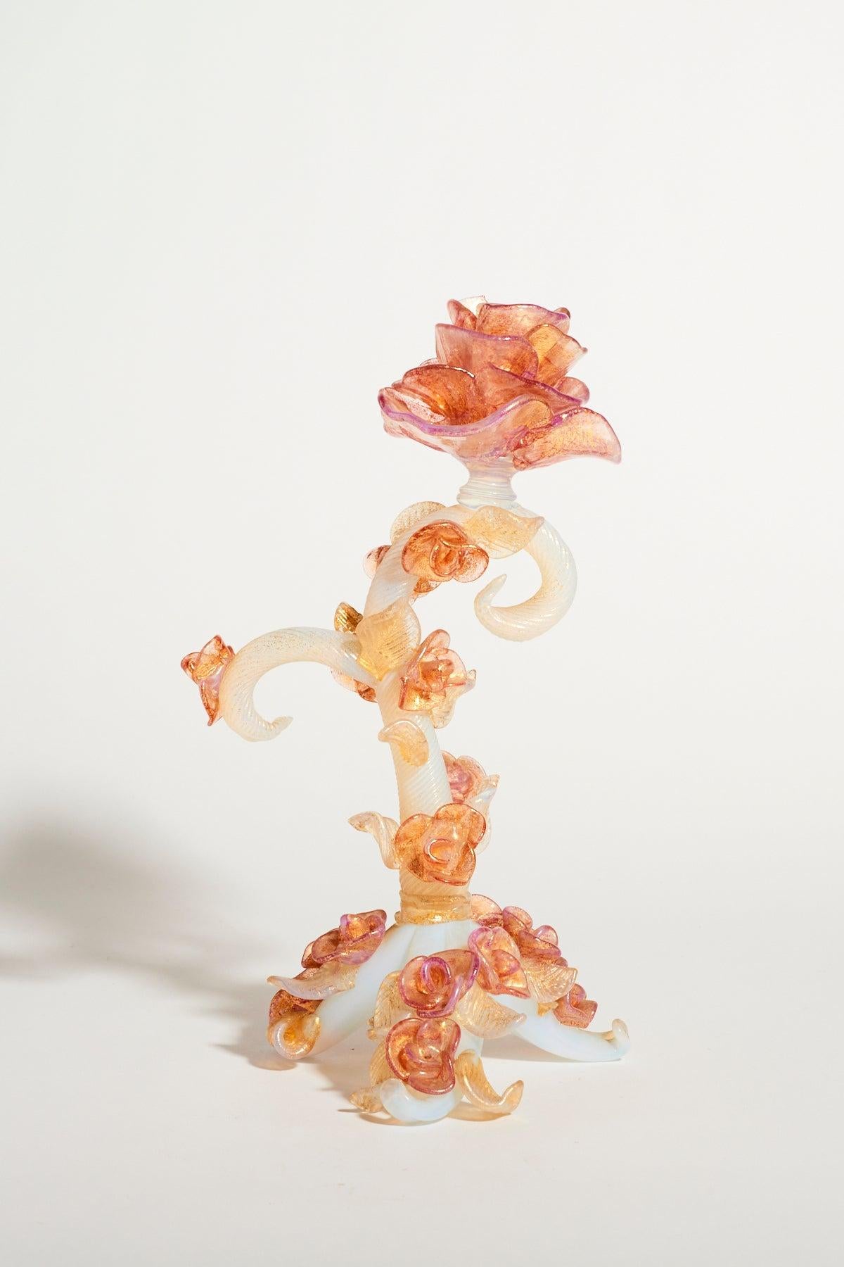 Murano rose vine candle holder, opalescent white stem entwined with buds and leaves in gold flecked peach, pink and clear glass with a full blown rose at the top.
 