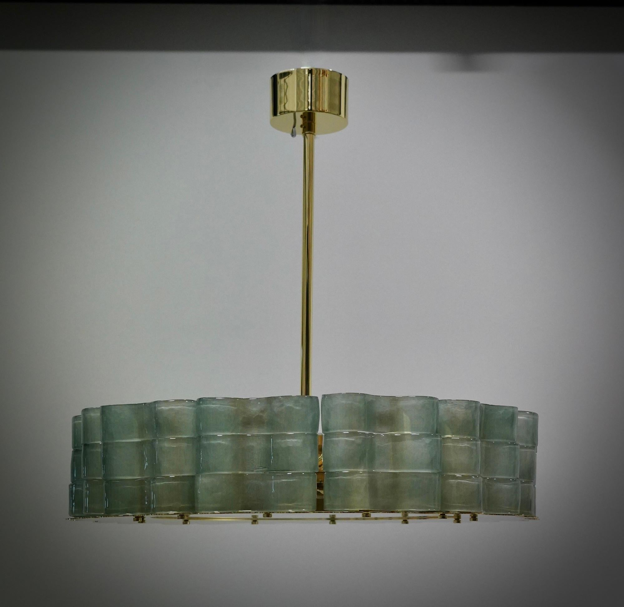 Fantastic round chandelier in Murano glass and polished brass. Note the shape of the blue Murano glass curls, very beautiful and particular. Simple but very elegant linear Murano chandelier.

Murano chandelier in artistic glass and brass. Formed by