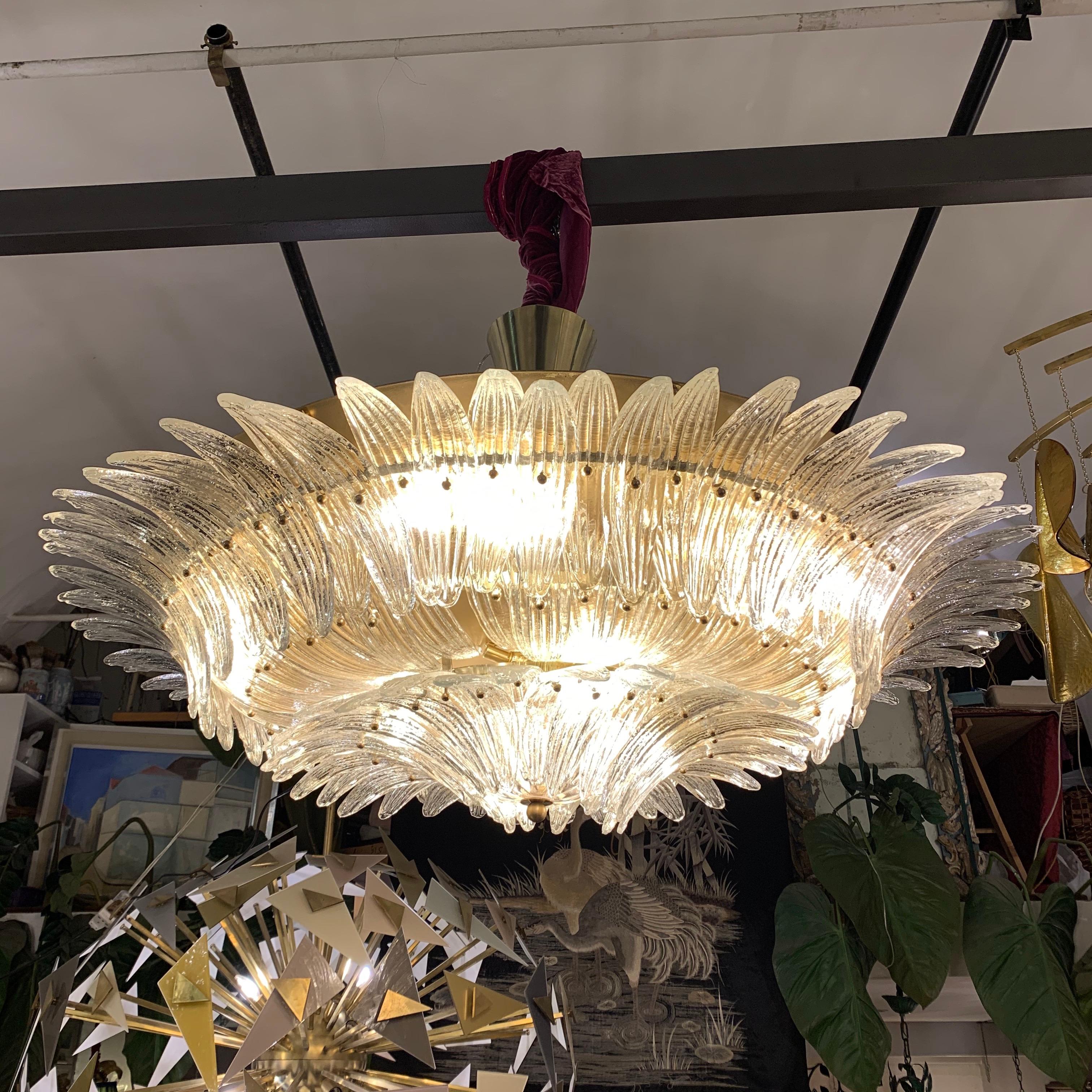 Murano round chandelier with multitude of hand blown clear glass leaves, brass structure and fittings, 18 light bulbs.
The weight is about Kg 100.
