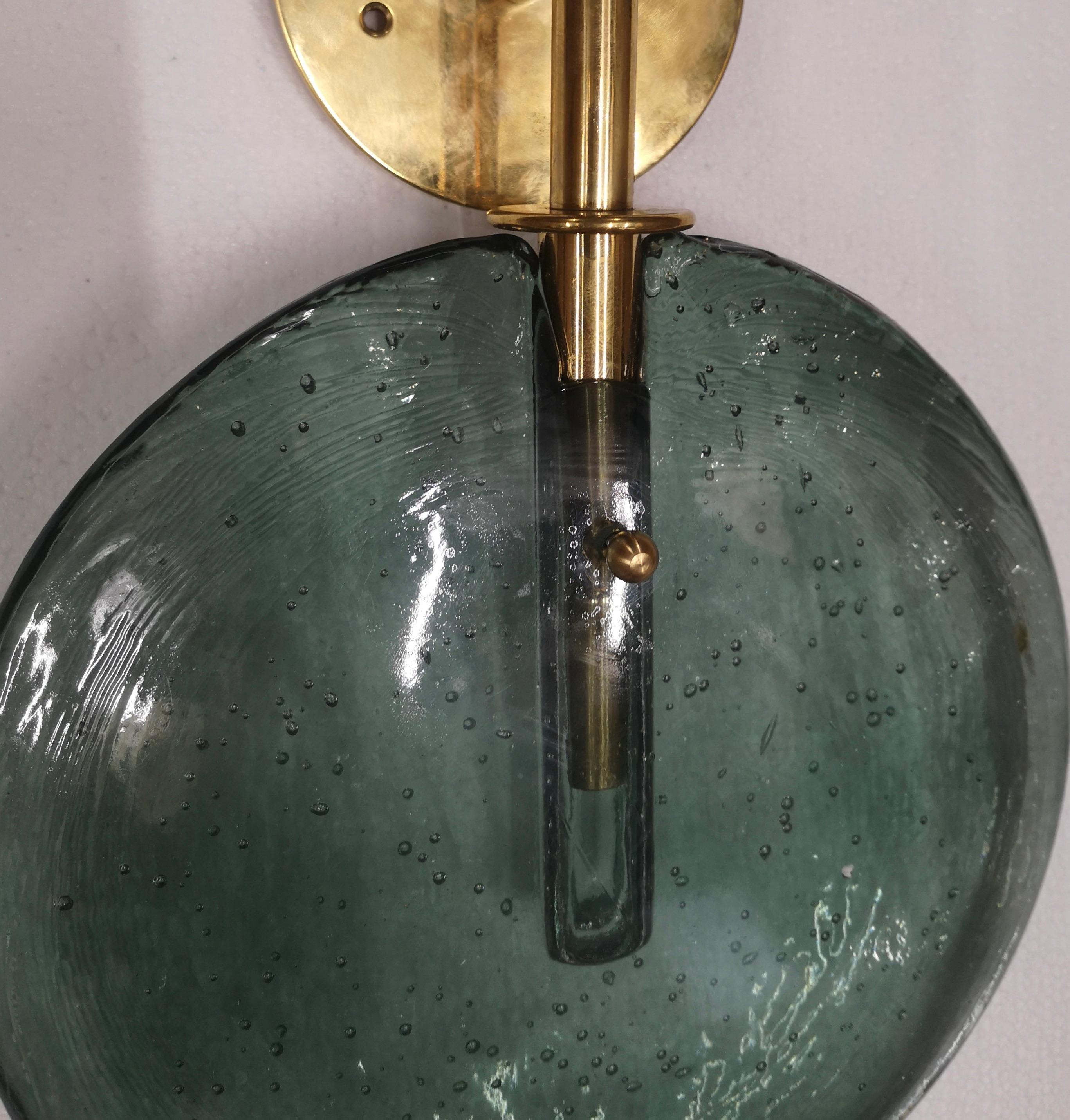 Very special Murano glass wall light, stylish and elegant, their design truly unique in their kind. Beautiful coloring.

The wall light is composed of a brass stem where a system for a G9 bulb has been inserted; this implant for the G9 bulb is