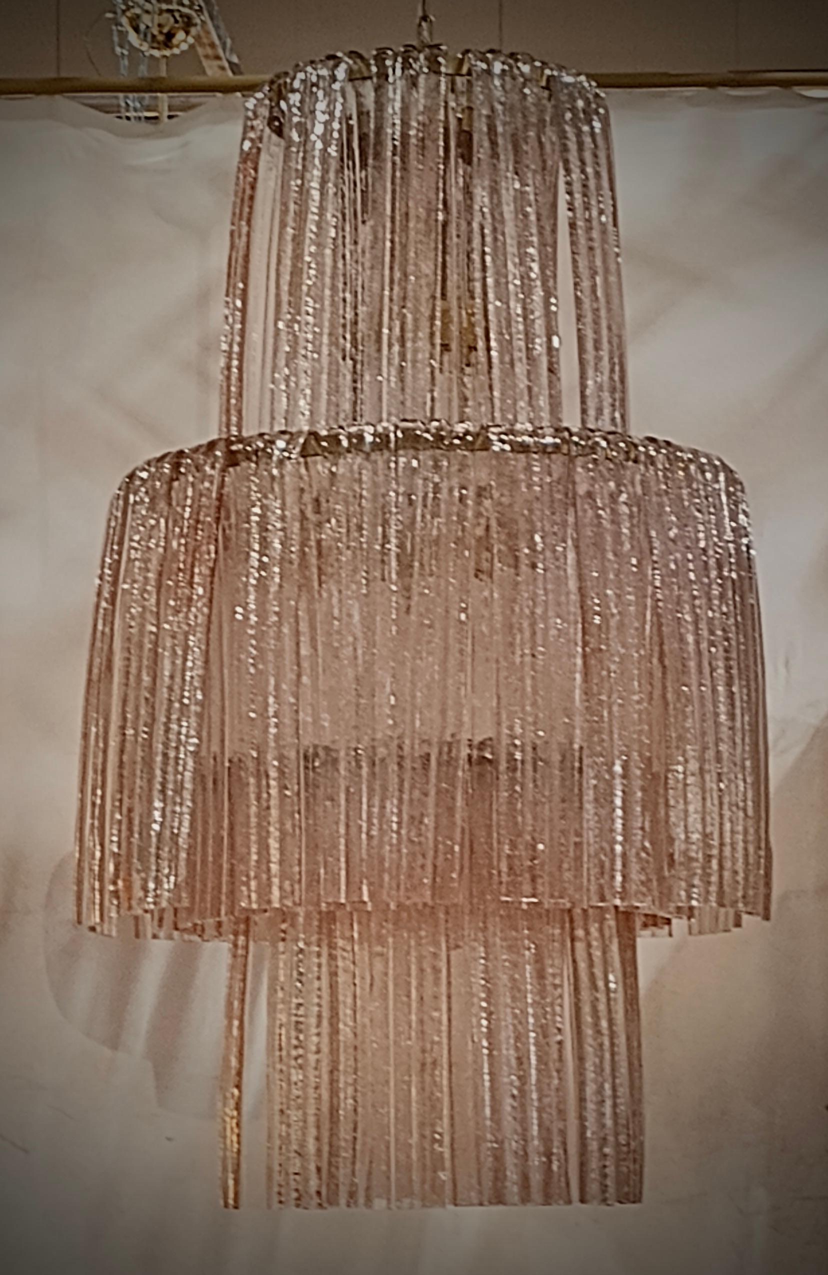 Wonderful and elegant, pink in colour, like the flower of the same name, this perfect round chandelier, created and produced in Murano immediately after the second half of the 20th century.

The entirely white iron structure is made up of three