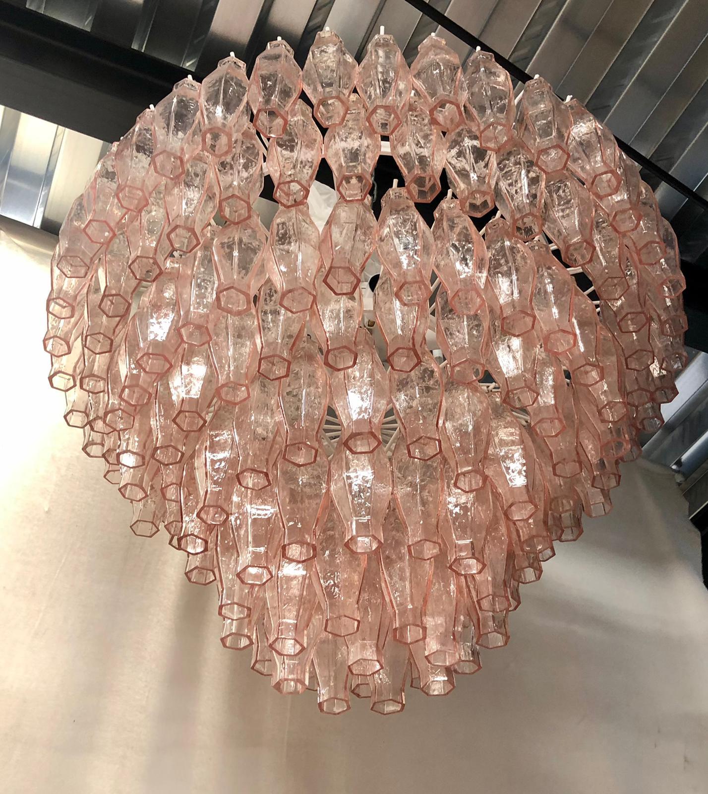 Splendid Murano glass chandelier with a particular transparent pink color. Its design is also very particular round but pyramidal in height. The Murano furnaces create an indisputable timeless design, simple but elegant at the same time.

The