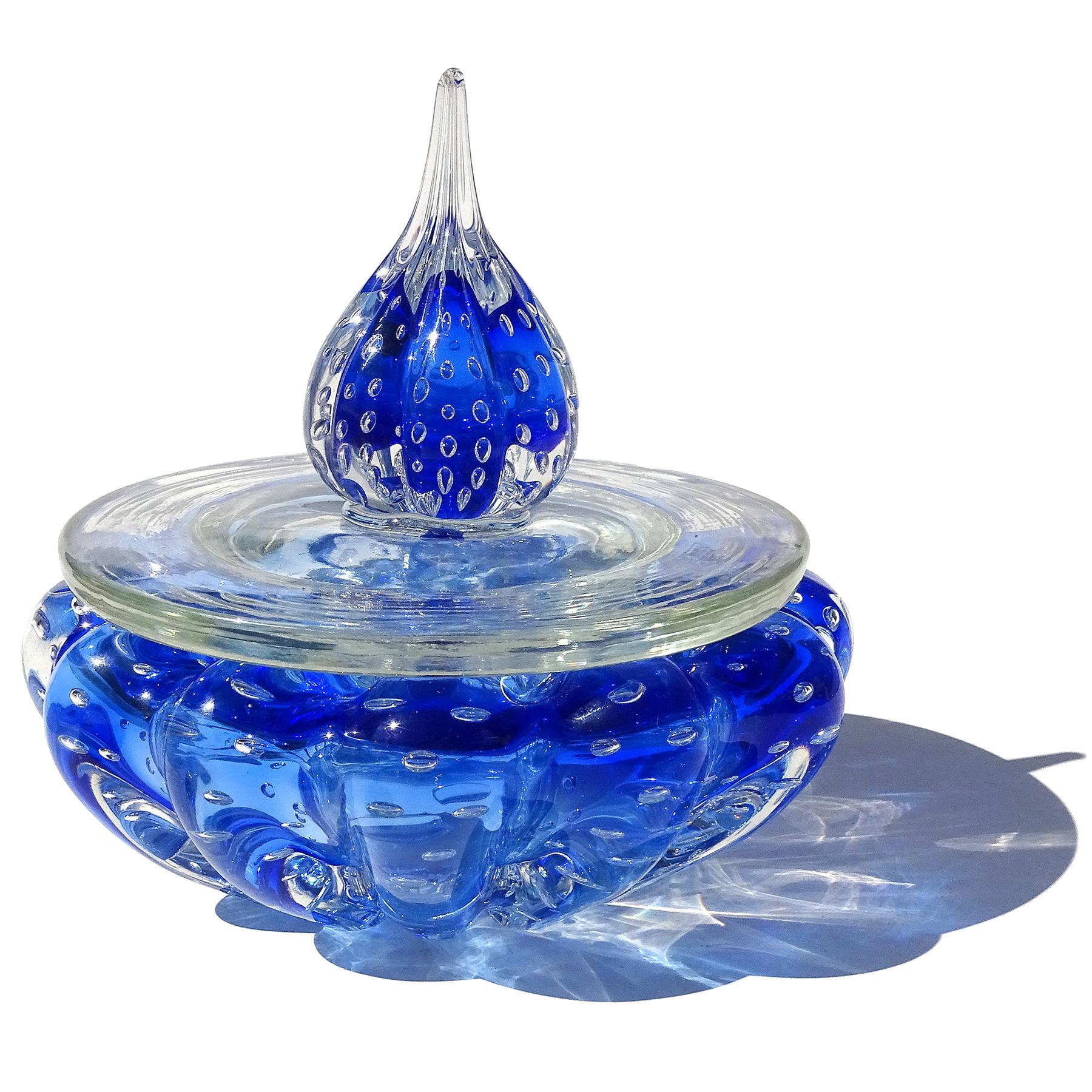 Beautiful vintage Murano hand blown Sommerso sapphire blue and bubbles Italian art glass lidded vanity dresser jar. The piece has a ribbed body, with large clear lid and spike topper. Made in the 