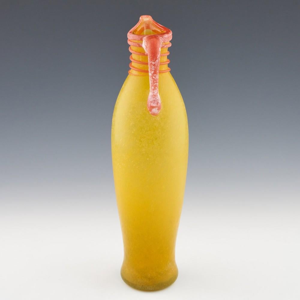 Murano Scavo Glass Ewer, c1970

Additional information:
Date : 1960-80
Origin : Murano, Italy
Bowl Features : Yellow glass with light orange lip handle and trailing. The glassmaker has utilised the scavo technique - the application of various