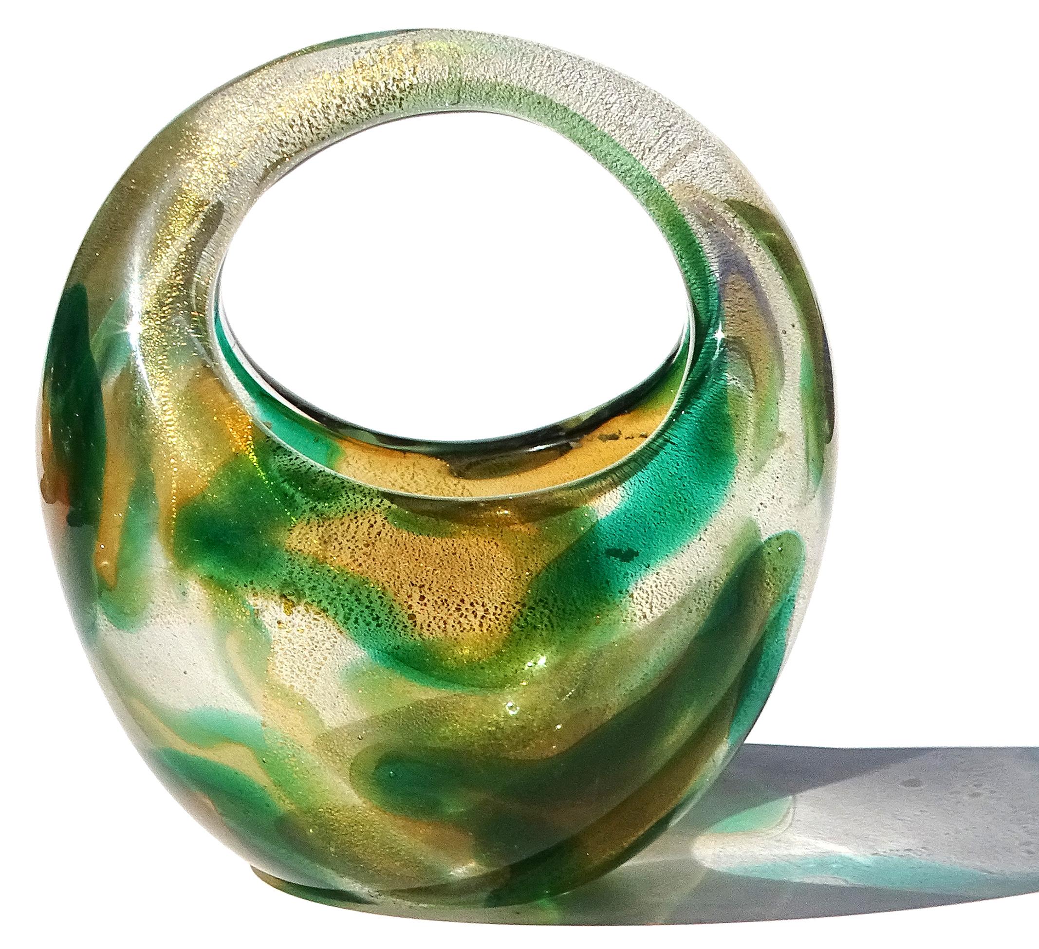 Beautiful vintage Murano hand blown Sommerso green, orange amber spots and gold flecks Italian art glass decorative basket / vase. The piece is documented to designer Archimede Seguso, circa 1952. This design has been published in many Seguso books