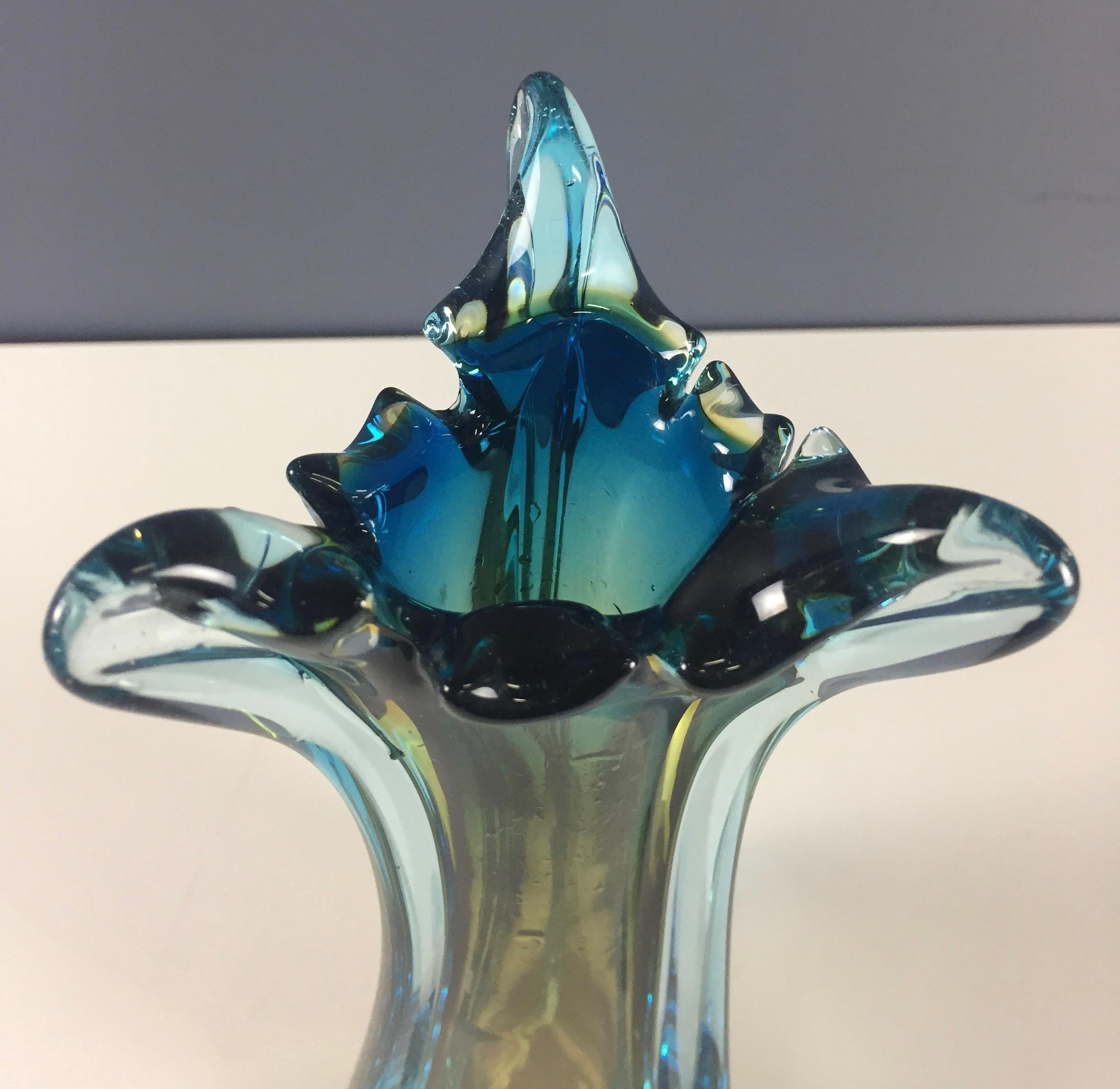 Beautiful and colorful glass vase in blues, greens and yellows. This vase is a real stunner and is in perfect condition.