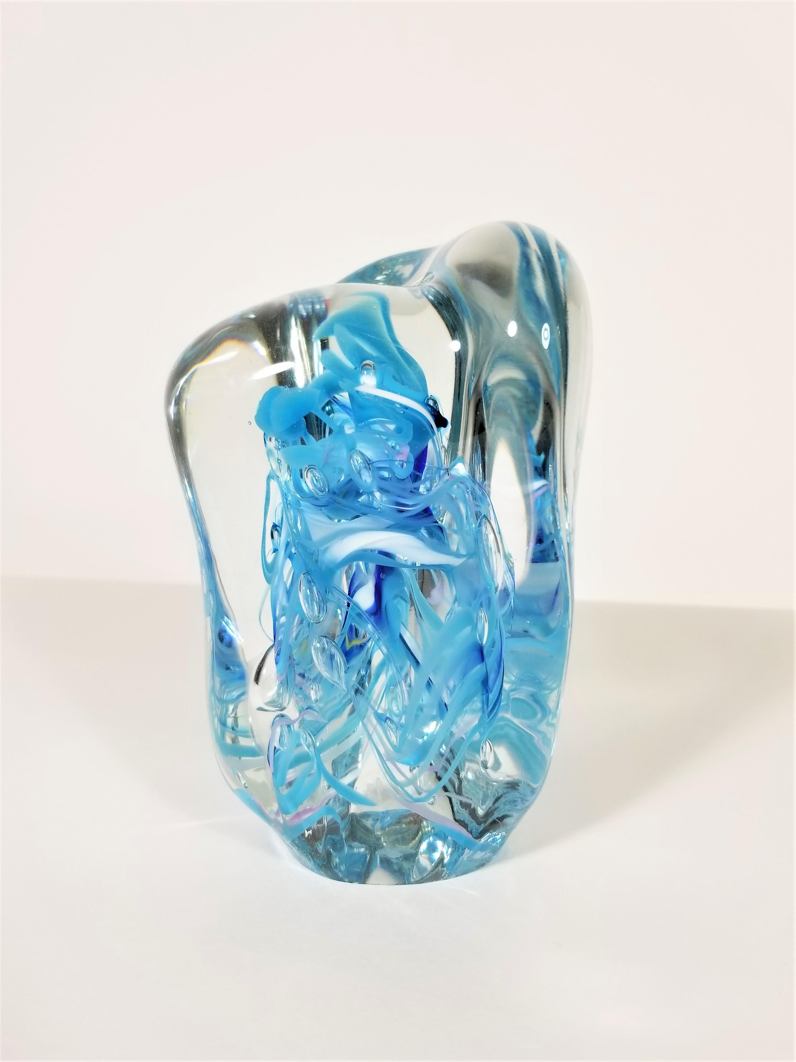 Signed Murano decorative art glass. Dated 1997. Sculptural shape. Blown glass design in varying shades of blue and white surrounded by clear glass. Substantial / Heavy in weight.
Excellent condition with exception of exhibiting minor wear on bottom.