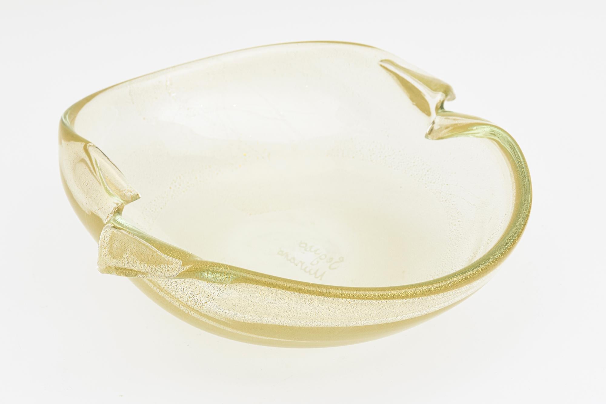 This over scaled elegant vintage Murano blown glass bowl is signed by Seguso. It is abundant with gold aventurine and the top portion has hints of light green at the top. it has beautiful light of gold to it. It is from the island of Murano from the
