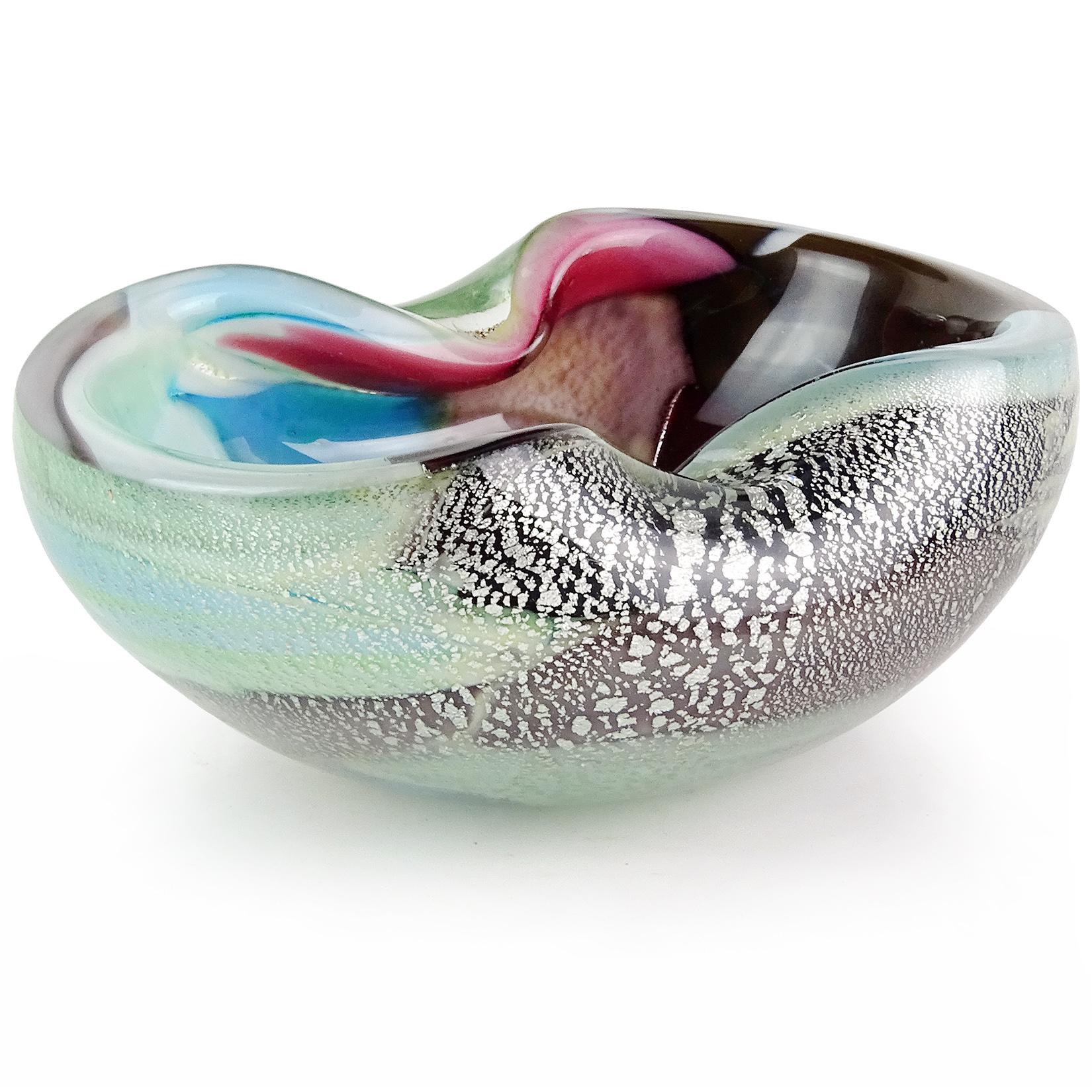 Beautiful vintage Murano hand blown multi-color and silver flecks Italian art glass bowl. The bowl has patches of different colors, like pink, teal, blue, brown, orange, and red. Created in the manner of designer Dino Martens. Can be used as a