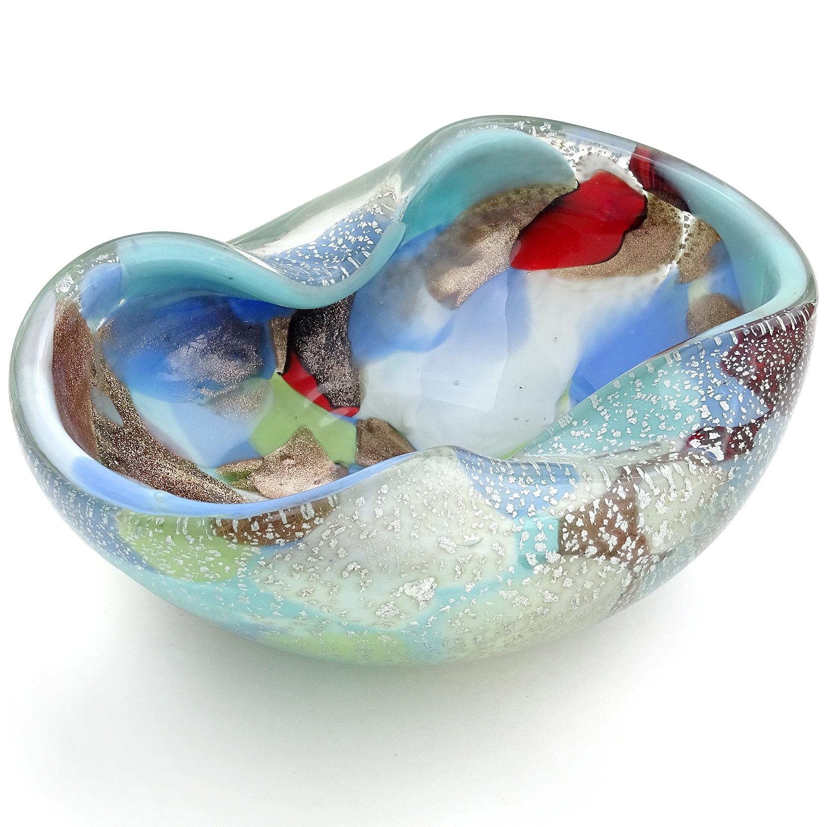 Beautiful Murano hand blown multi-color and silver flecks Italian art glass bowl. The bowl has patches of different colors, like teal green, powder blue, white, yellow, and red. Profusely covered in silver leaf. Has large patches of copper