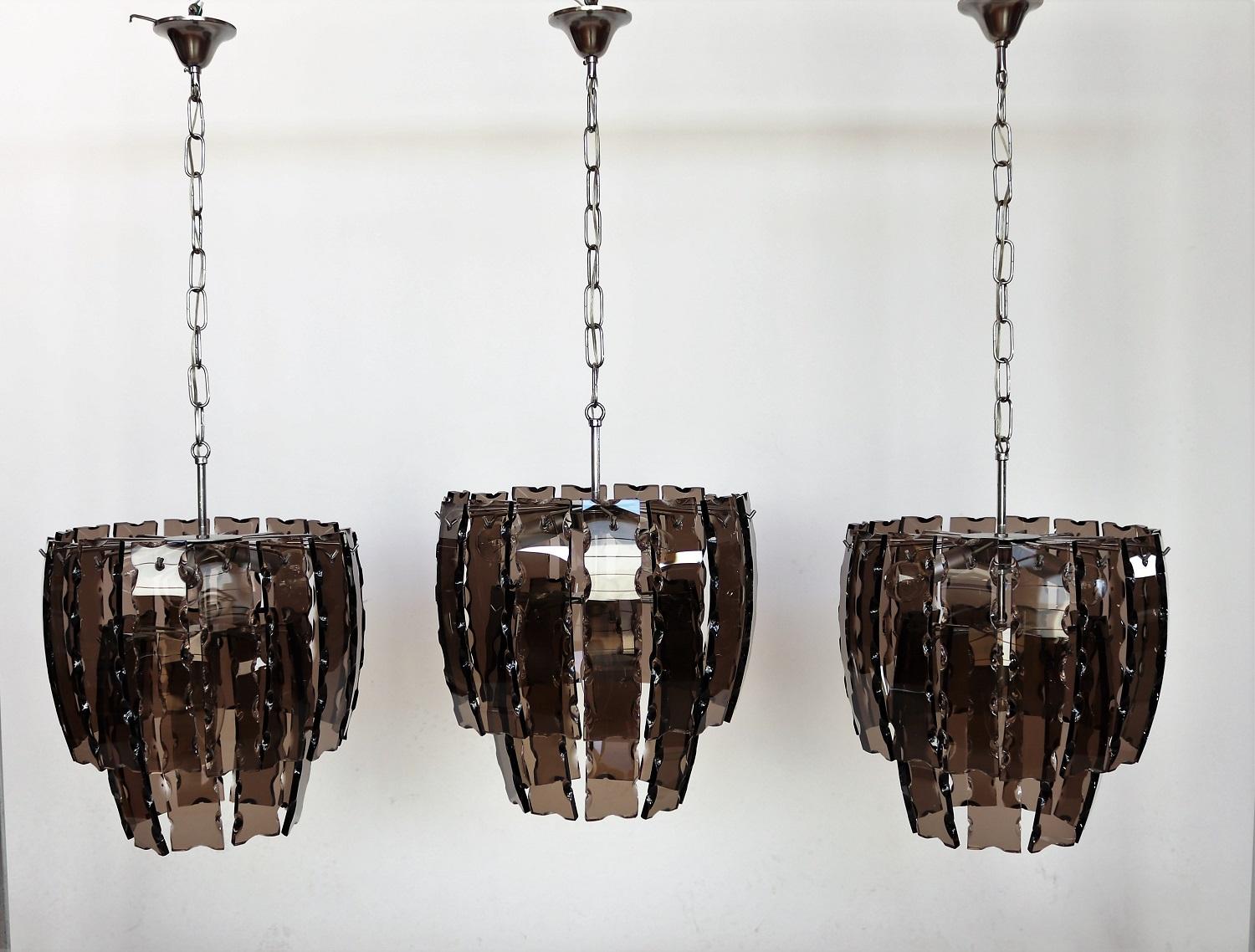 Wonderful smoke / dark brown glass chandeliers from Murano with chromed lamp base.
Made in Italy in the 1970s.
Three same pieces available but sold separately.
The lamps are in wonderful vintage and working condition and can be used
