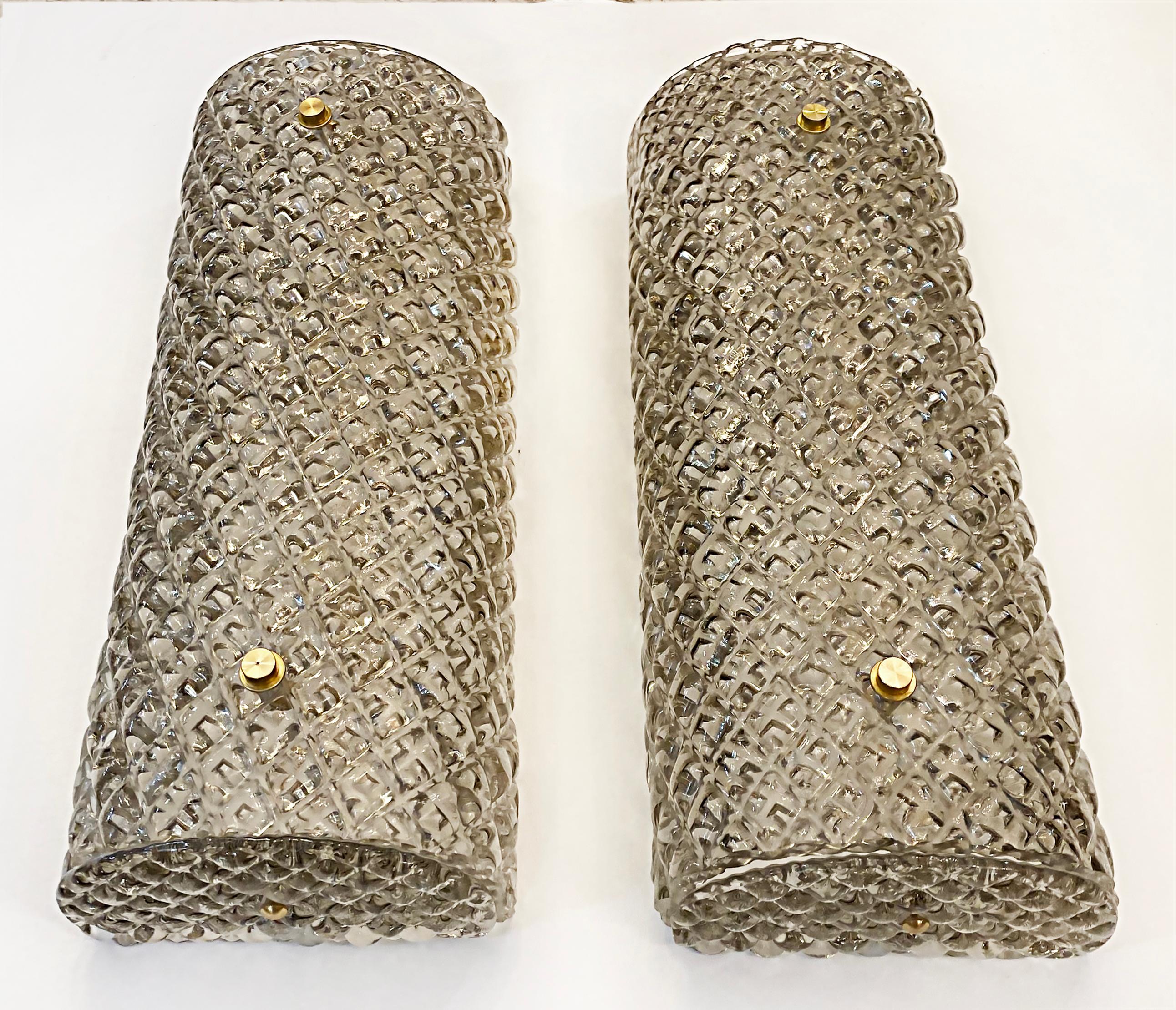 Murano Smoked Textured Glass Wall Sconces, Available Now

Offered for sale is a pair of Murano textured, smoked glass wall sconces which are available for immediate delivery from our shop in Miami. The sconces are in current production and