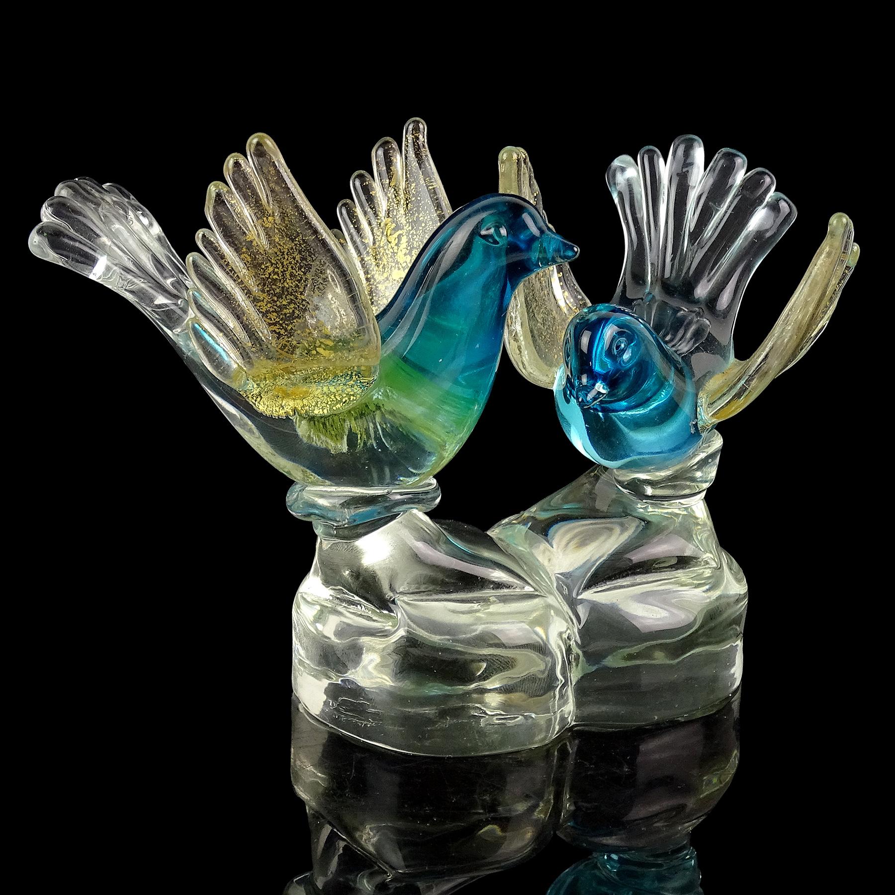 Beautiful vintage Murano hand blown Sommerso aqua blue and gold flecks Italian art glass bird figurines paperweight sculpture. Documented to designer Alfredo Barbini. They look to be a pair of courting birds, beautifully sculpted and attached to a
