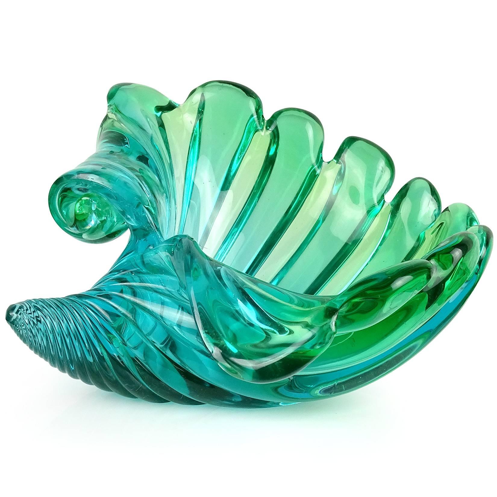 Beautiful vintage Murano hand blown Sommerso green to blue Italian art glass seashell bowl. The piece has a flared sculptural design with scroll decoration to one side. In the manner of designers Alfredo Barbini and Archimede Seguso. Can be used as