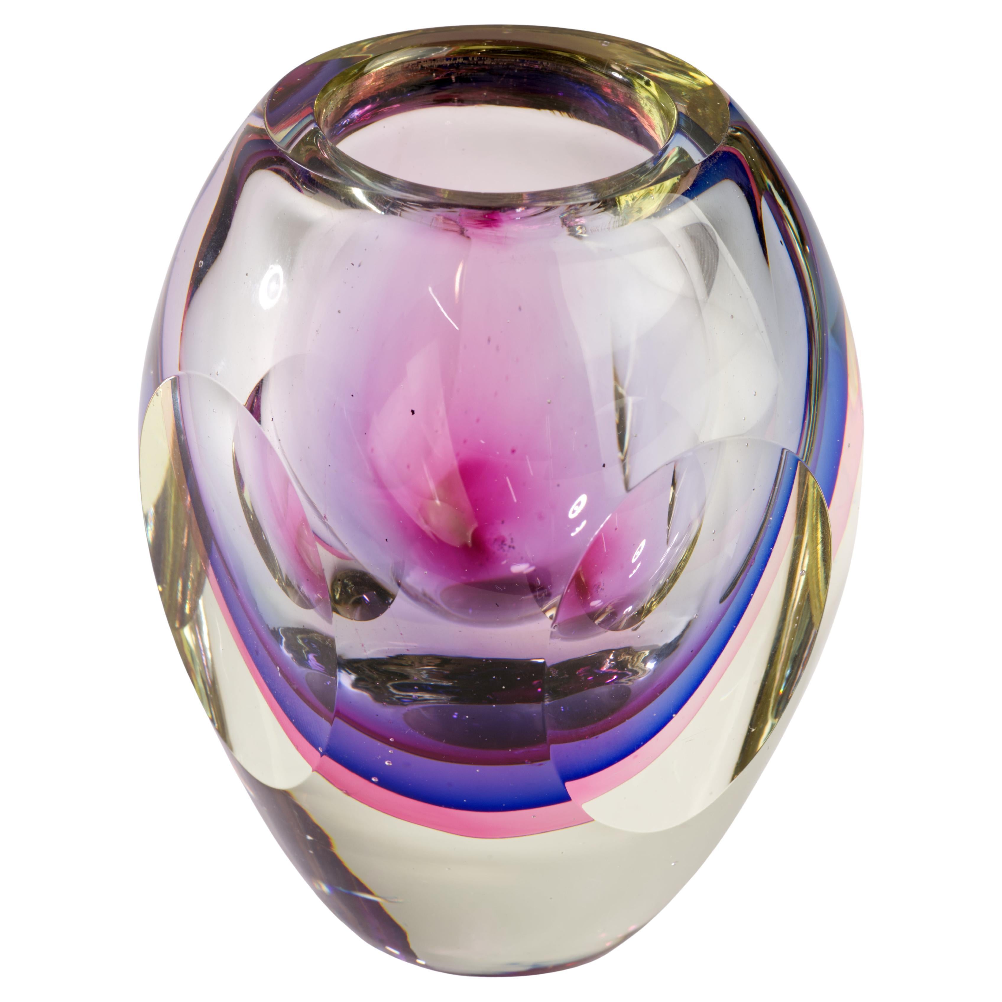  Vintage Murano glass vase was made with layers of cobalt blue, purple and pink glass encased inside of clear glass layer in sommerso technique. Faceted sides give it an elevated, sculptural appearance.

The vase is in good vintage condition with