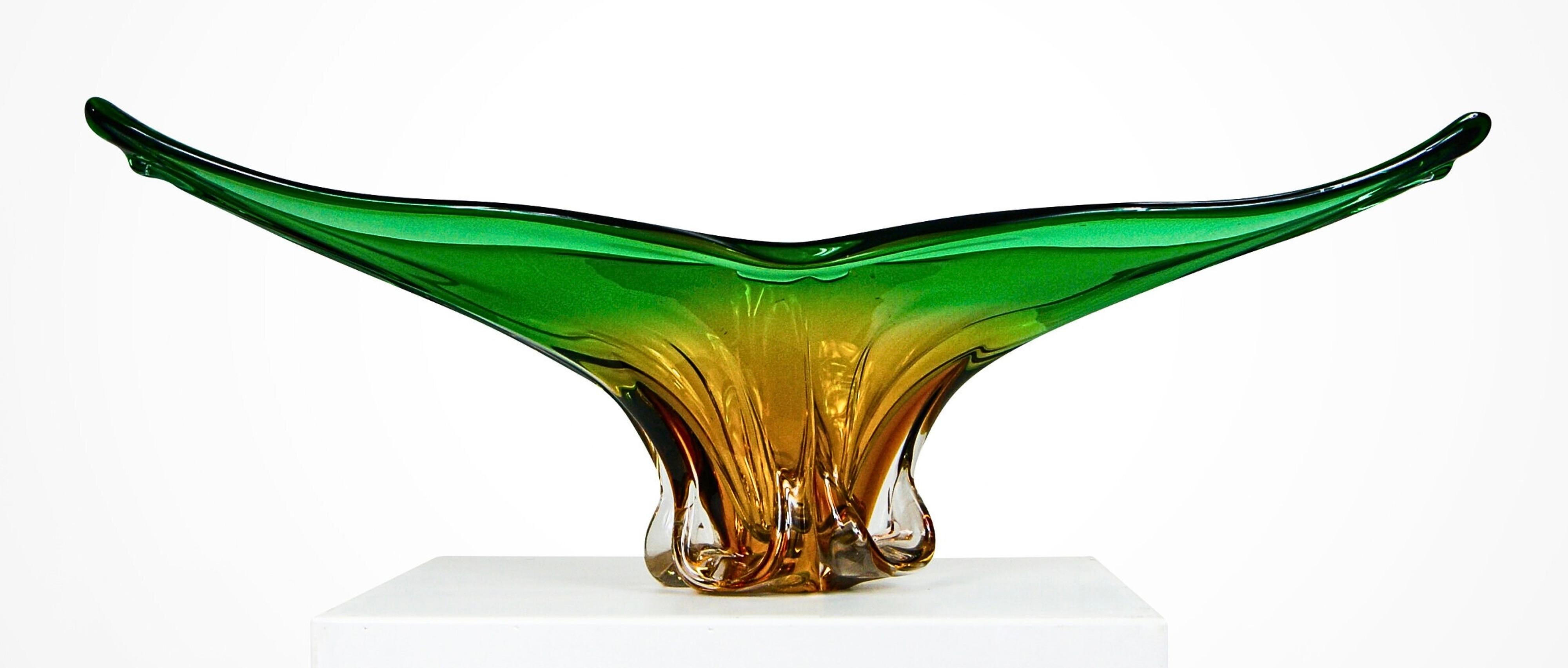 Monumental Murano amber and green sommerso glass bowl and matching vase.
Attributed to Cristallo Venezia circa 1960s.
Exquisite organic form sculptures with a combined pre-packaged weight of nearly 8kgs.
The bowl is a huge gondola shaped amber and