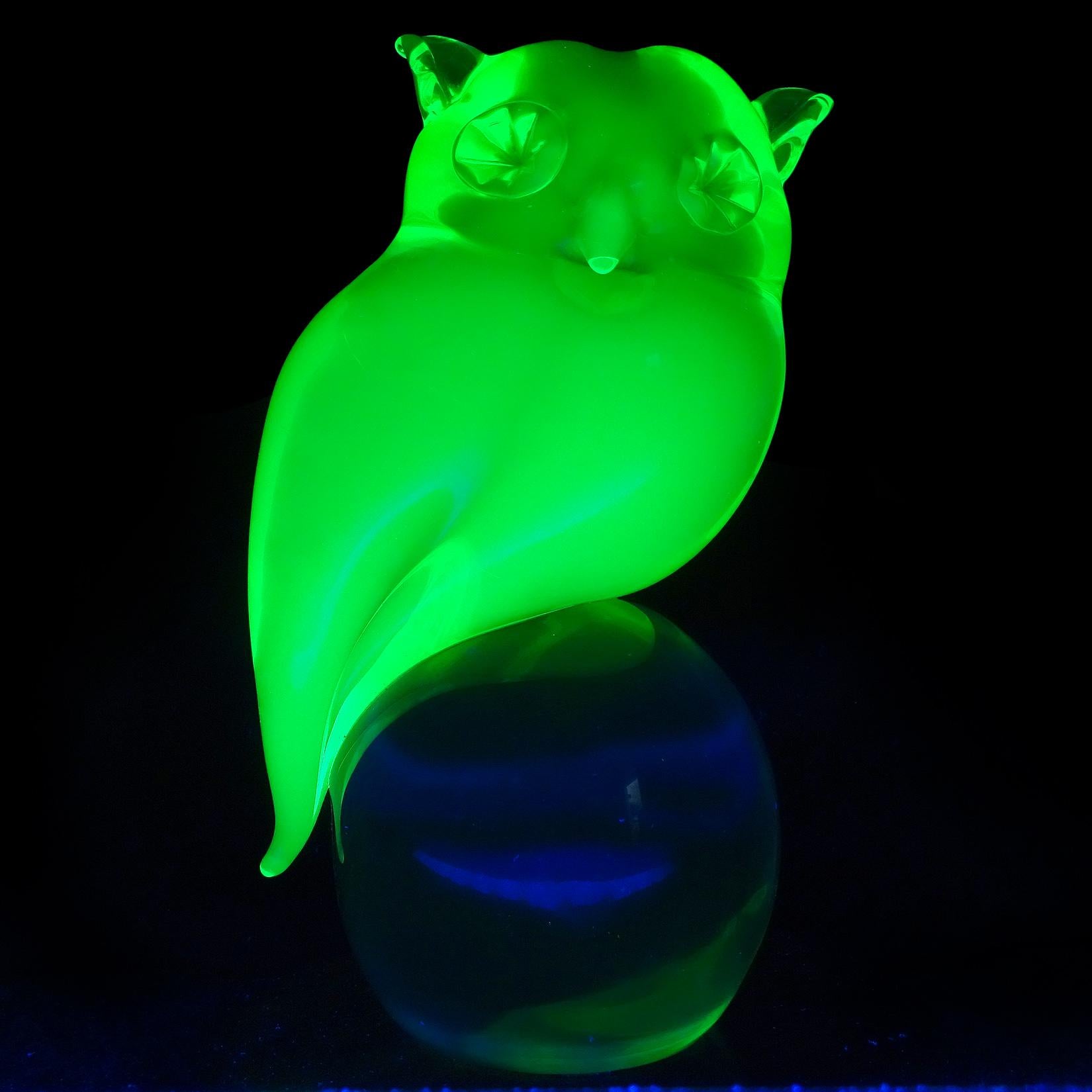 Beautiful, and large, vintage Murano hand blown Sommerso glowing Uranium green Italian art glass owl bird sculpture standing on a clear ball base. Attributed to the Salviati company, and to designer Livio Seguso. The bird is nicely sculpted, with