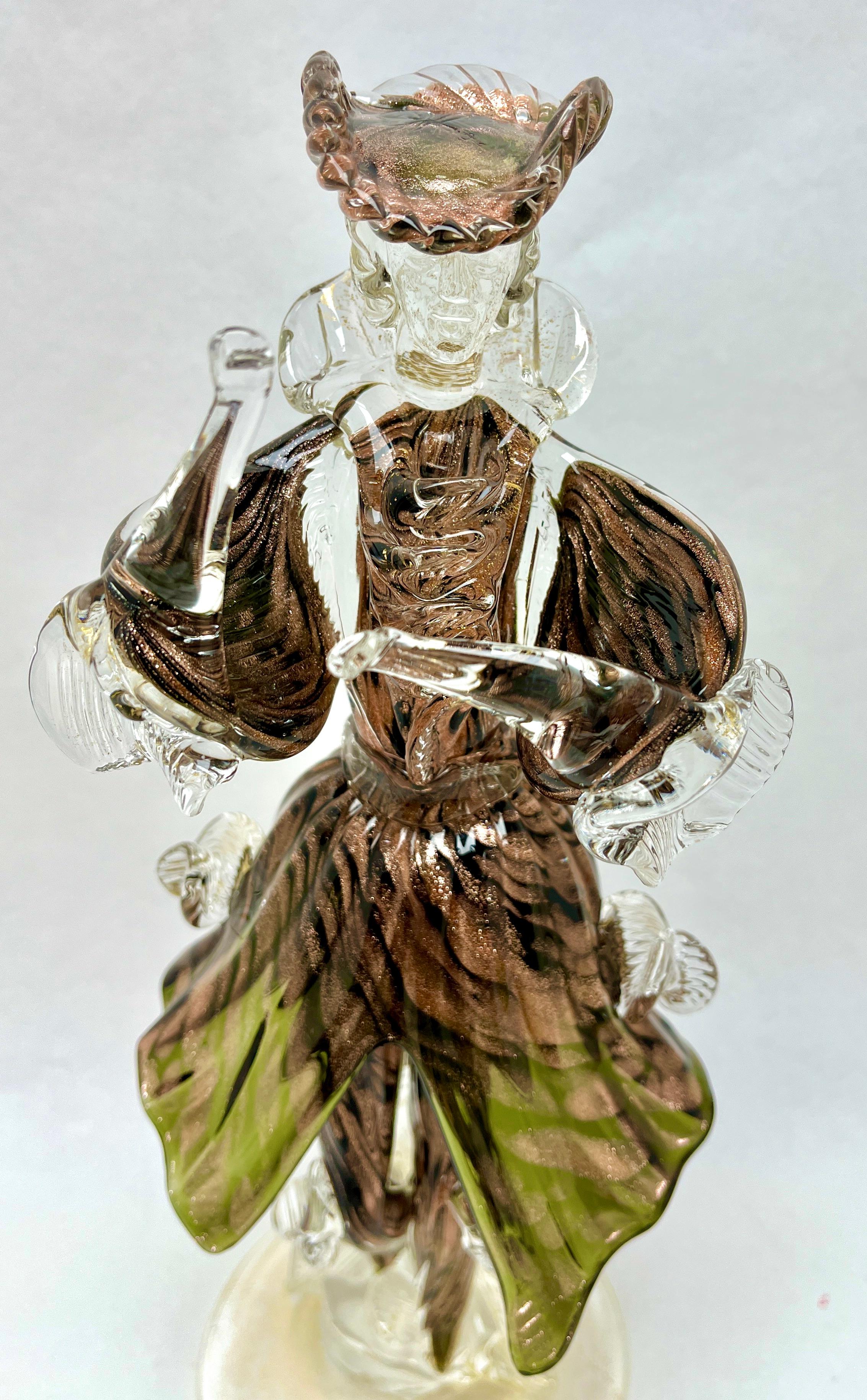 Murano Sommerso gold flecks Italian art glass harlequin figurine.

Beautiful murano hand blown sommerso and gold flecks Italian art glass harlequin Sculpture.
The piece is Profusely covered in gold Leaf. Nice Detailed.

Please don't hesitate to