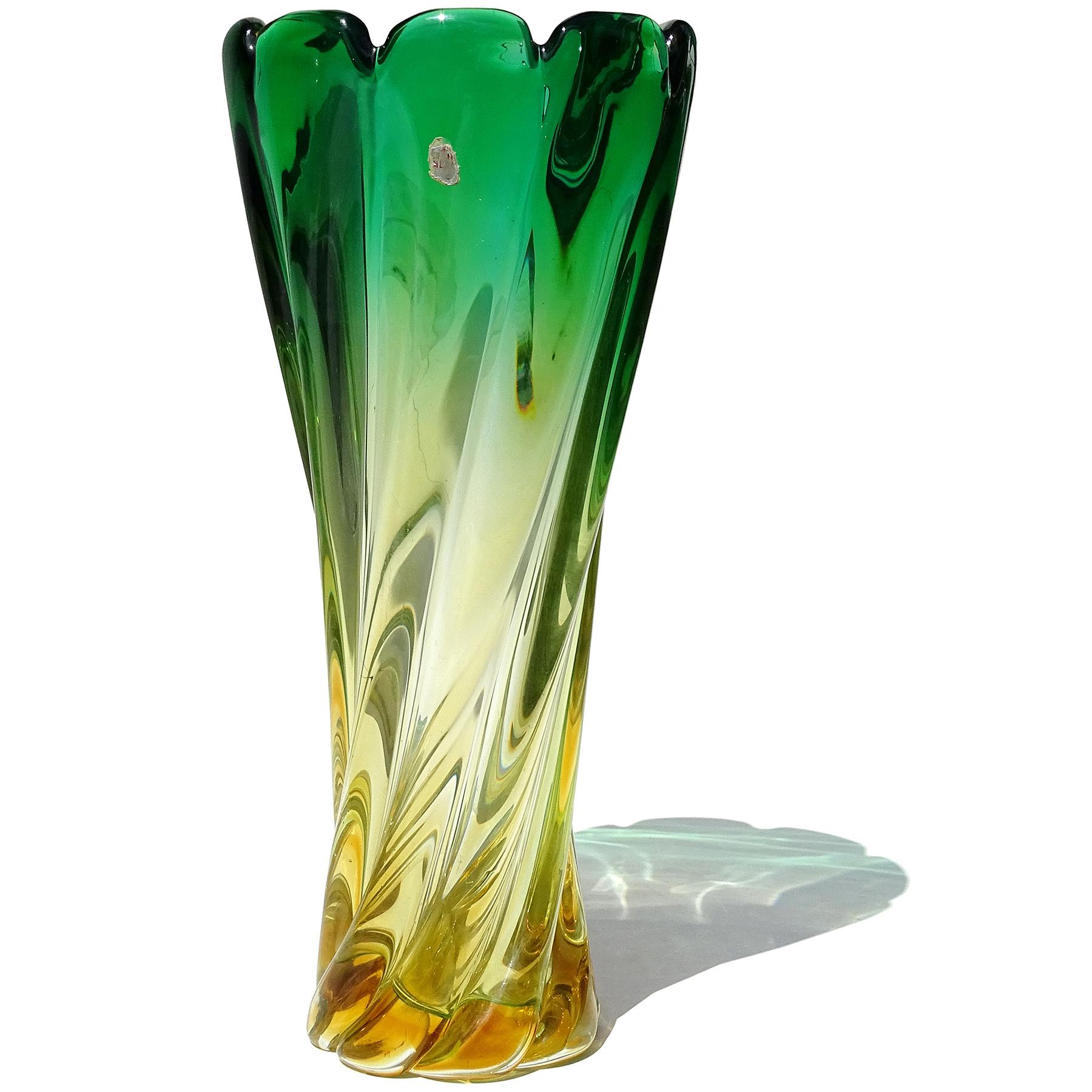 Beautiful vintage Murano hand blown Sommerso green to golden yellow orange Italian art glass flower vase. The vase has a small and worn Murano label on the top front. It also has a swirling ribbed surface, with large open top, looking like an open