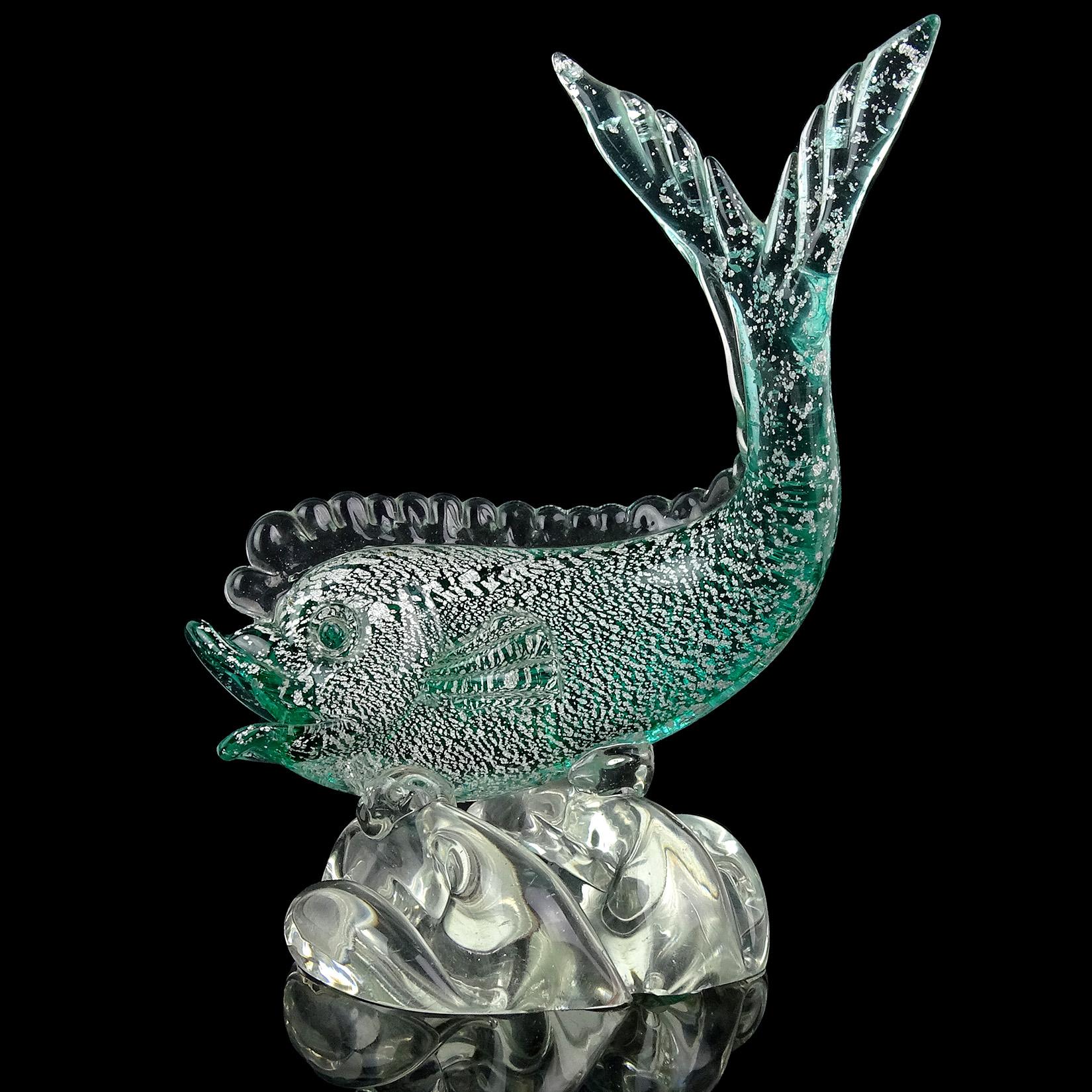 Beautiful early Murano hand blown Sommerso green Italian art glass fish sculpture, covered in silver leaf. In the manner of the Seguso Vetri D' Arte company, circa 1940s. The fish stands on a wave of water. Art Deco - Mid-century era. Measures 8