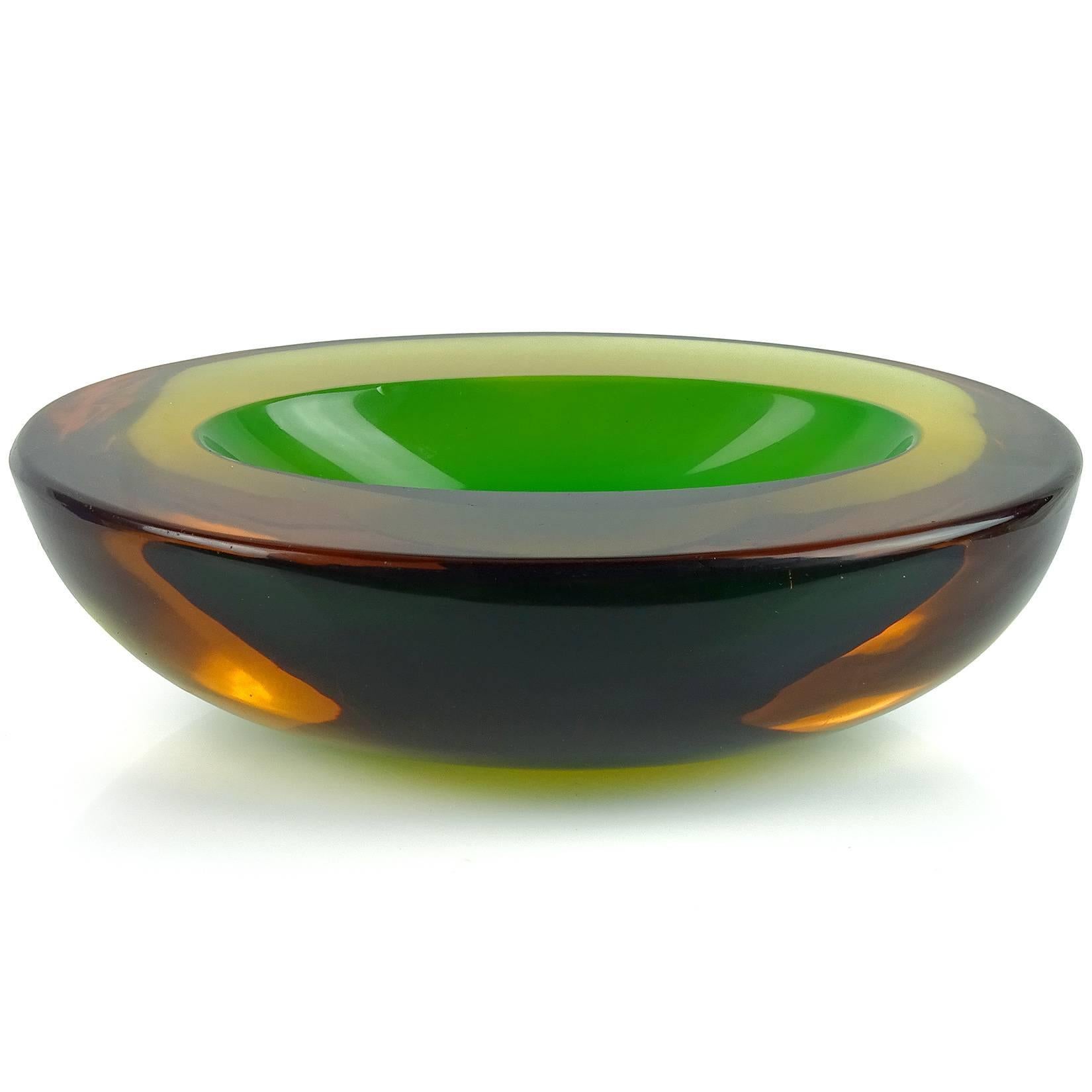 Beautiful Murano hand blown Sommerso yellow, orange amber and green Italian art glass bowl. Attributed to designer Flavio Poli, for the Seguso Vetri d'Arte company. The piece is very thick and heavy, with an oval shape and flat cut rim. Measures: 7
