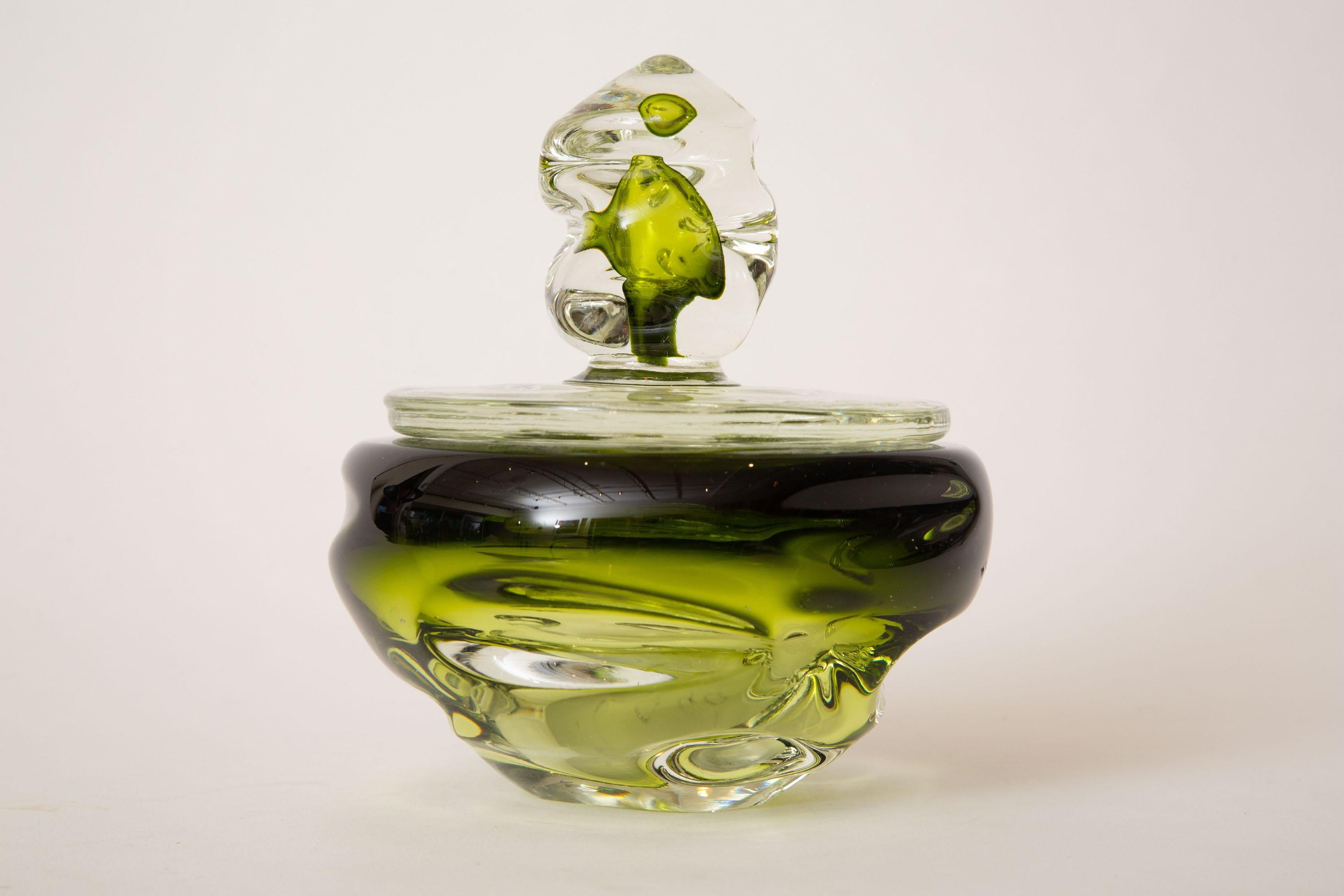 This luscious Italian Murano glass 2 part bowl or box has layerings of sommerso greens against clear. The kelly green, meets army green meets emerald green is beautiful. It has forms of indentations in the glass. This can be used for multiple