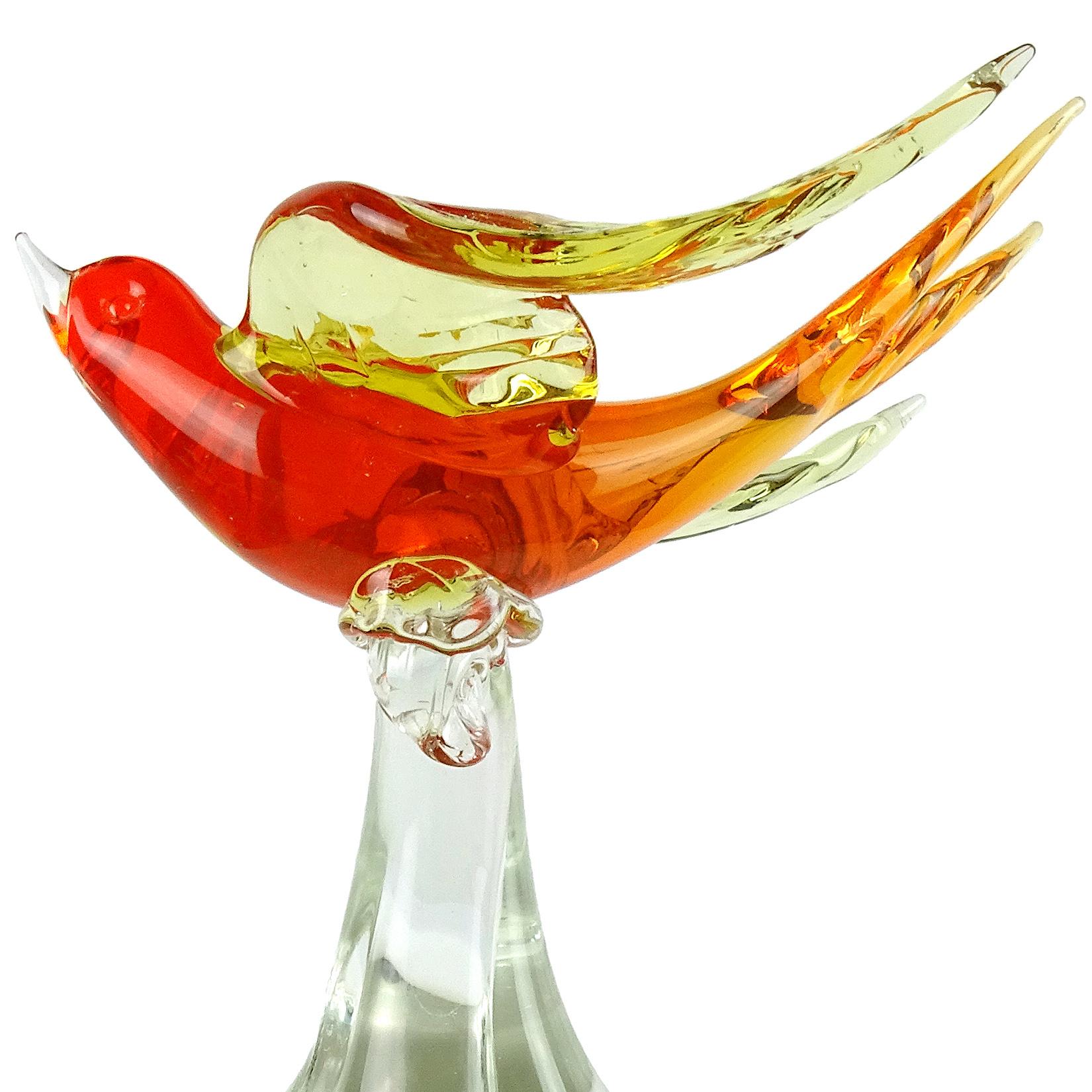 Beautiful vintage Murano hand blown Sommerso orange with yellow wings Italian art glass flying bird sculpture. Attributed to the Salviati company. The bird glides while a clear glass base holds him up. Very nicely detailed wings. The bird looks to