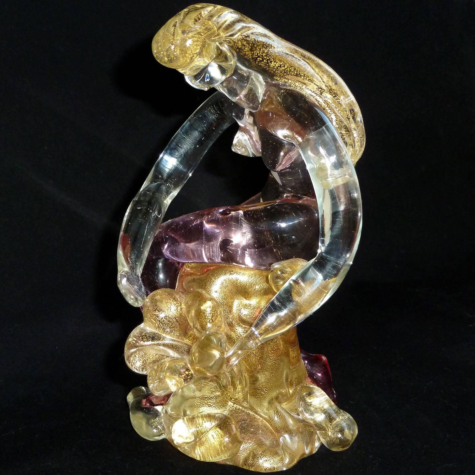 Gorgeous vintage Murano hand blown pink Sommerso and gold flecks Italian art glass nude woman, garden nymph figurine. The woman is tending to a large gold flower. Her body is highly detailed, with gold leaf throughout. Measures: 6 1/4