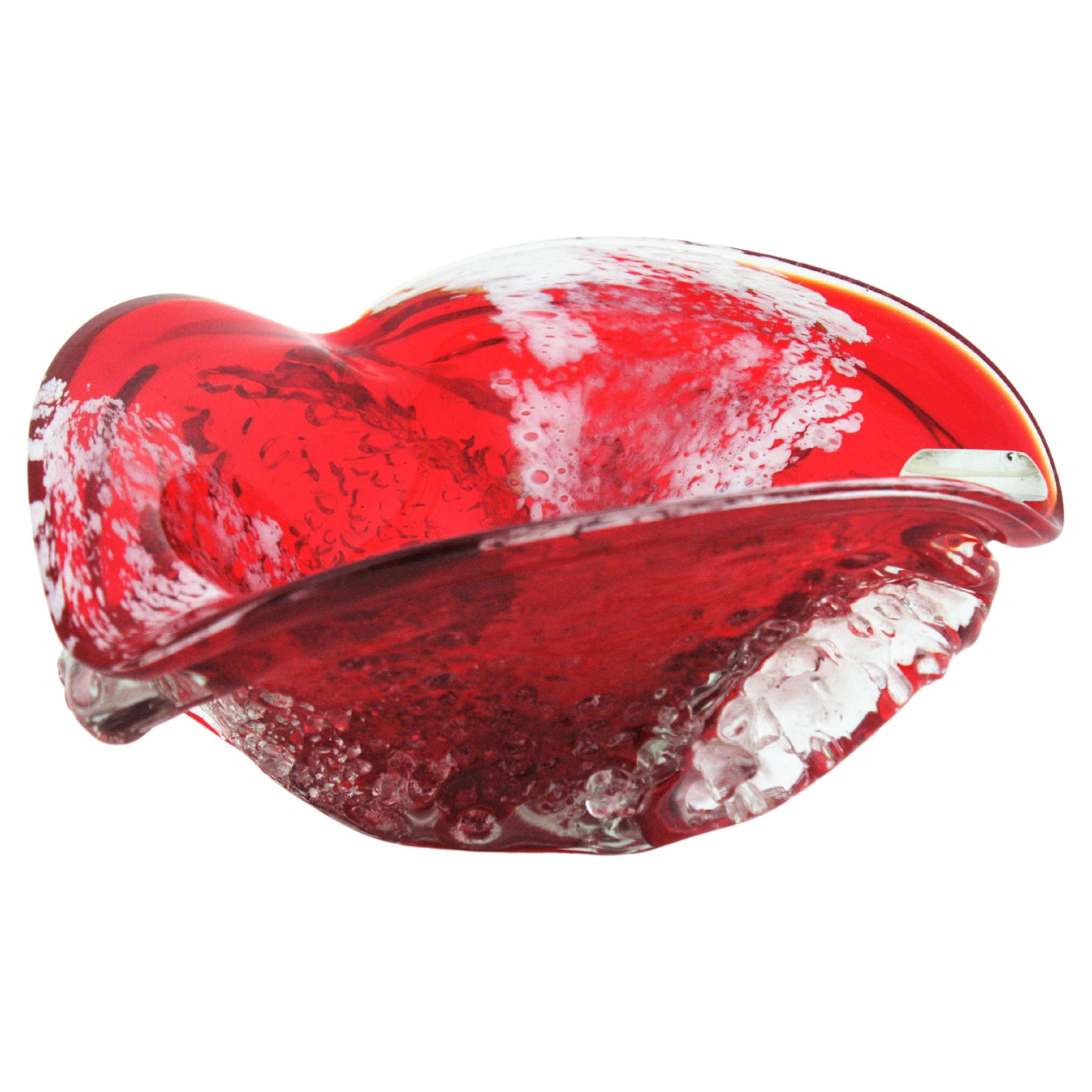 Hand blown Macette Murano glass ashtray, red, white and clear glass, Italy, 1950s.
This eye-catching triangular bowl is made with red glass submerged into clear glass. It has accents in white and the outer surface is finished using the 'macette'