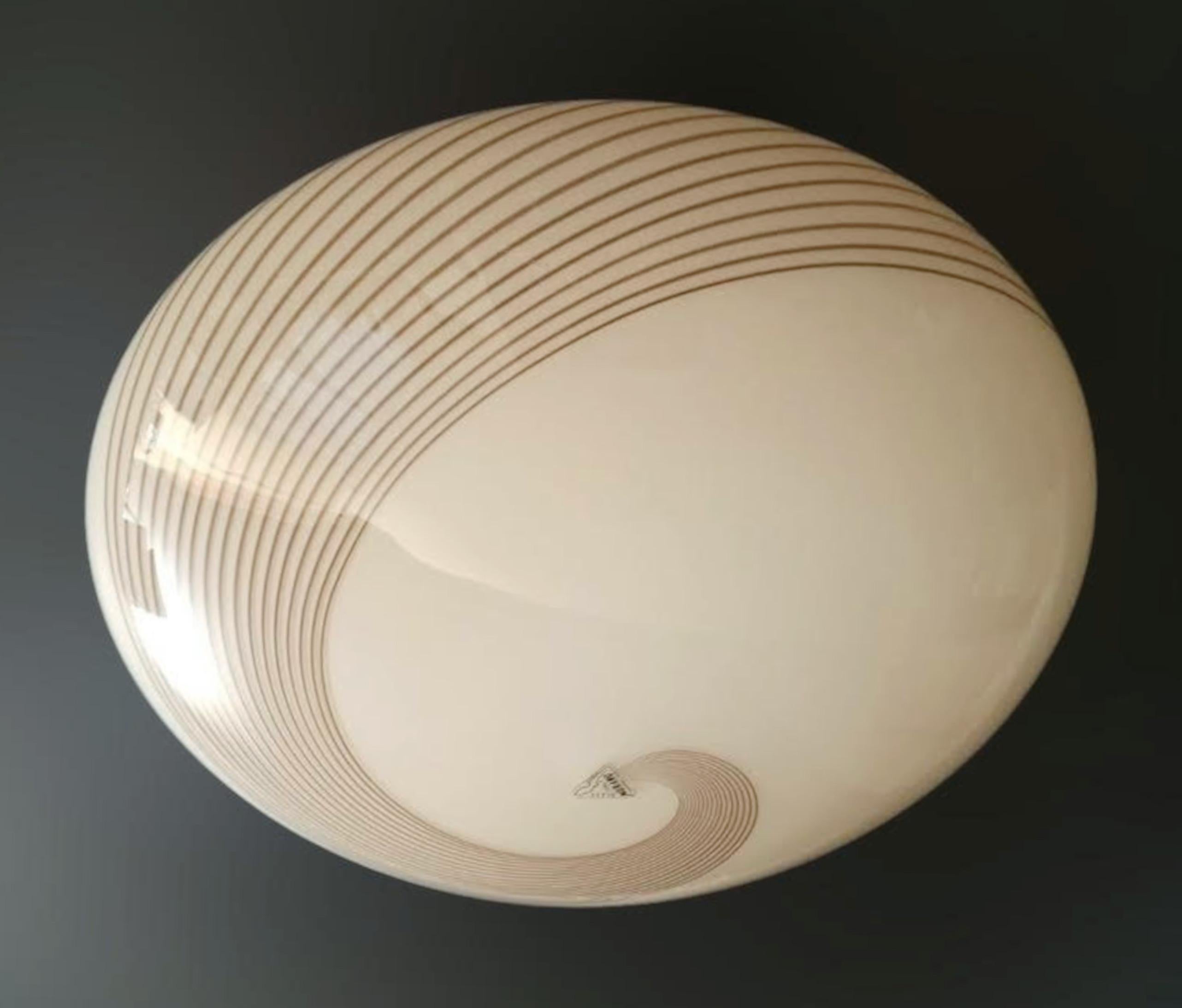 Vintage Italian flush mount or wall light of a cream colored Murano glass shade with an elegant spiral pattern / Made in Italy, circa 1960s
Measures: diameter 12 inches, height 6 inches
1 light / E26 or E27 type / max 60W
1 available in stock in