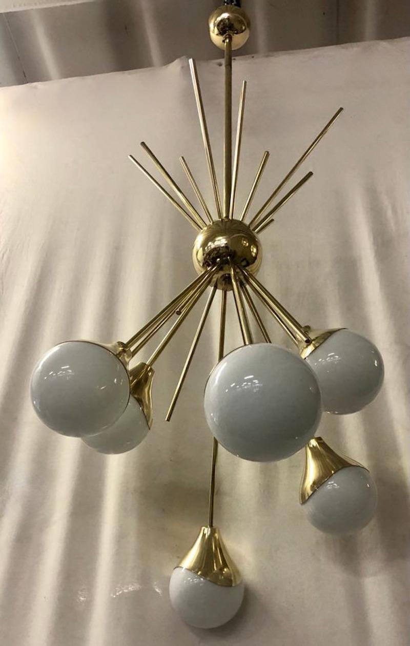 Different design for this sputnik with a simple and very linear flavor. All brass and white Murano glass. The Murano furnaces create an indisputable timeless design, simple but elegant at the same time.

The chandelier is made of a brass structure;