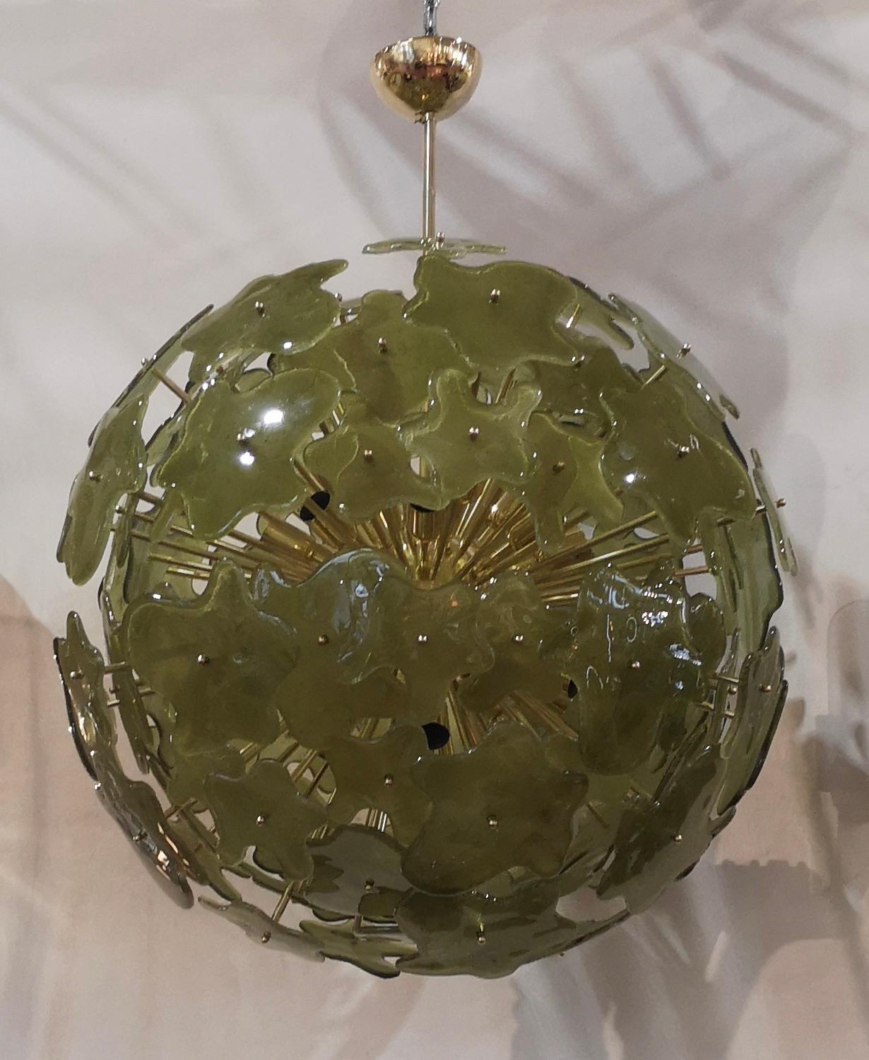 A fantastic spot of green color, amazing design due to its very particular shape of these green glass flowers and for the fantastic brass rods. Very elegant, will furnish and decorate your whole room.

Made of a large central sphere in which brass